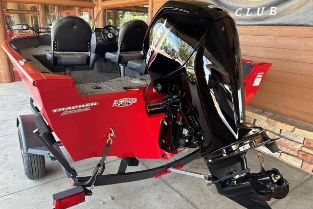 2026 Tracker Pro Guide V-16 SC boat with powerful outboard motor, red exterior.