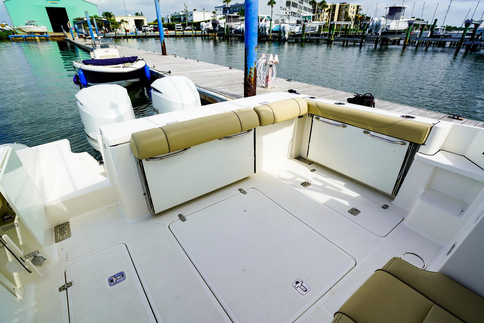 2020 Pursuit OS 325 Offshore boat interior with seating and dock view.