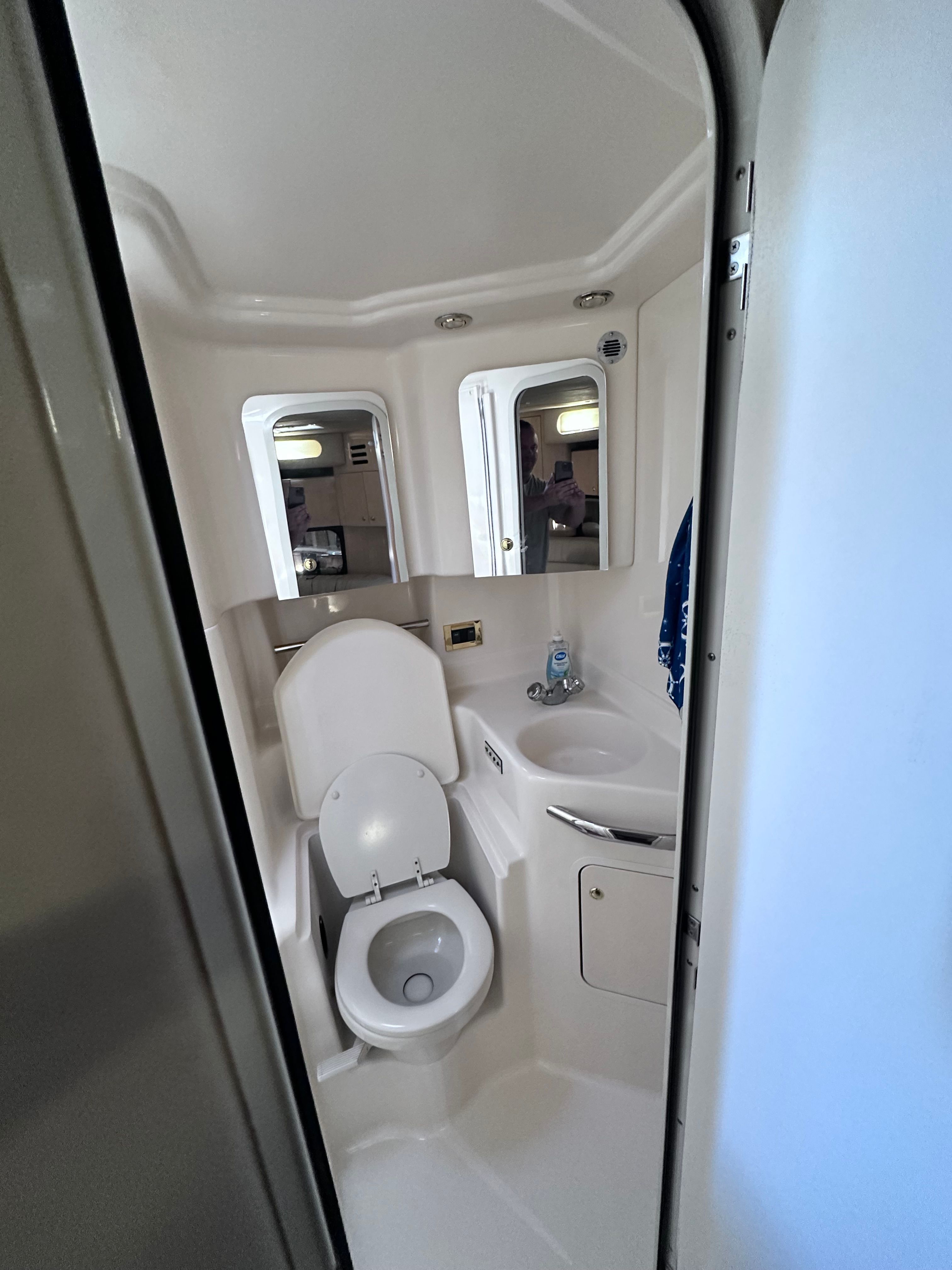 Compact bathroom in 2000 Sea Ray 380 Sundancer yacht, featuring toilet and sink.