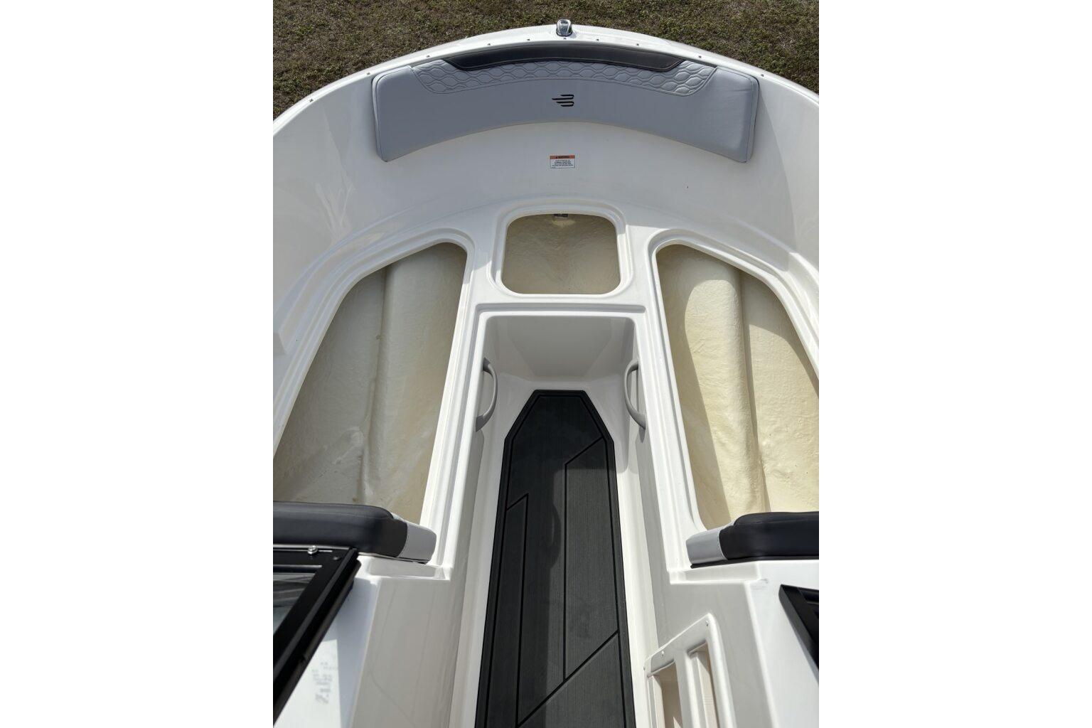 2025 Bayliner Element M17 boat interior with seating and storage compartments.