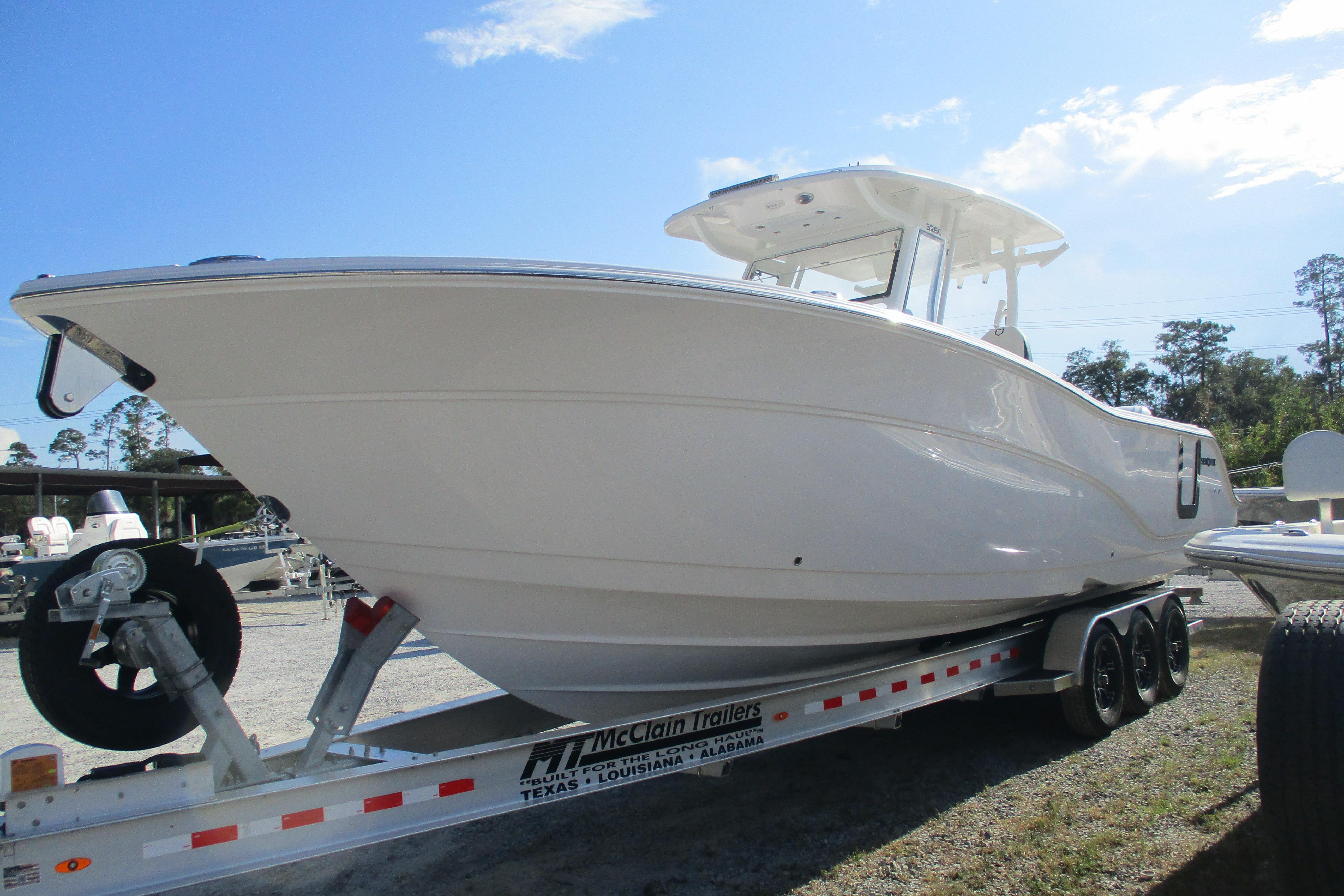 2026 Sea Fox 328 Commander boat on trailer under clear blue sky.