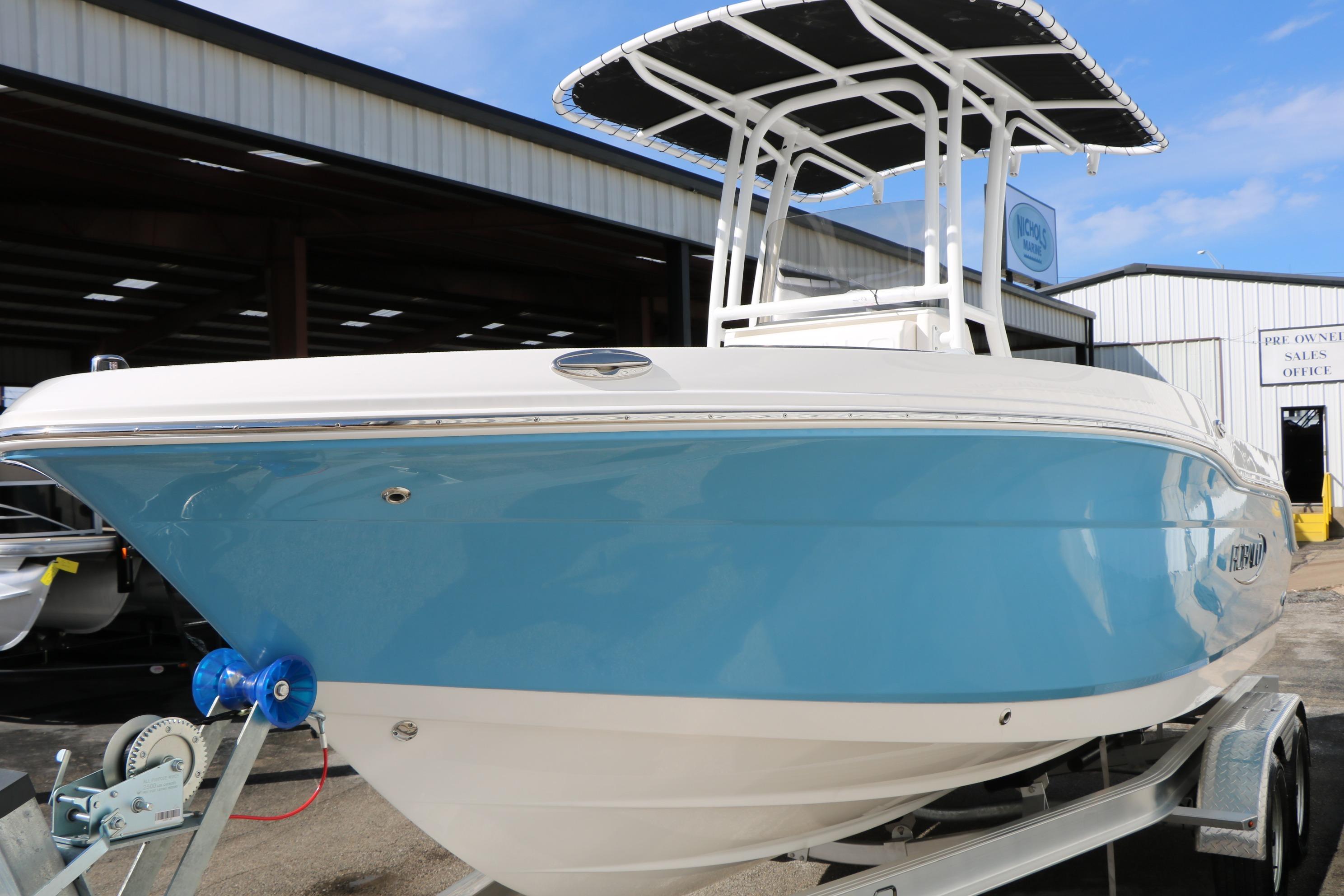 2026 Robalo R200 Center Console boat with blue hull on trailer, outdoor display.