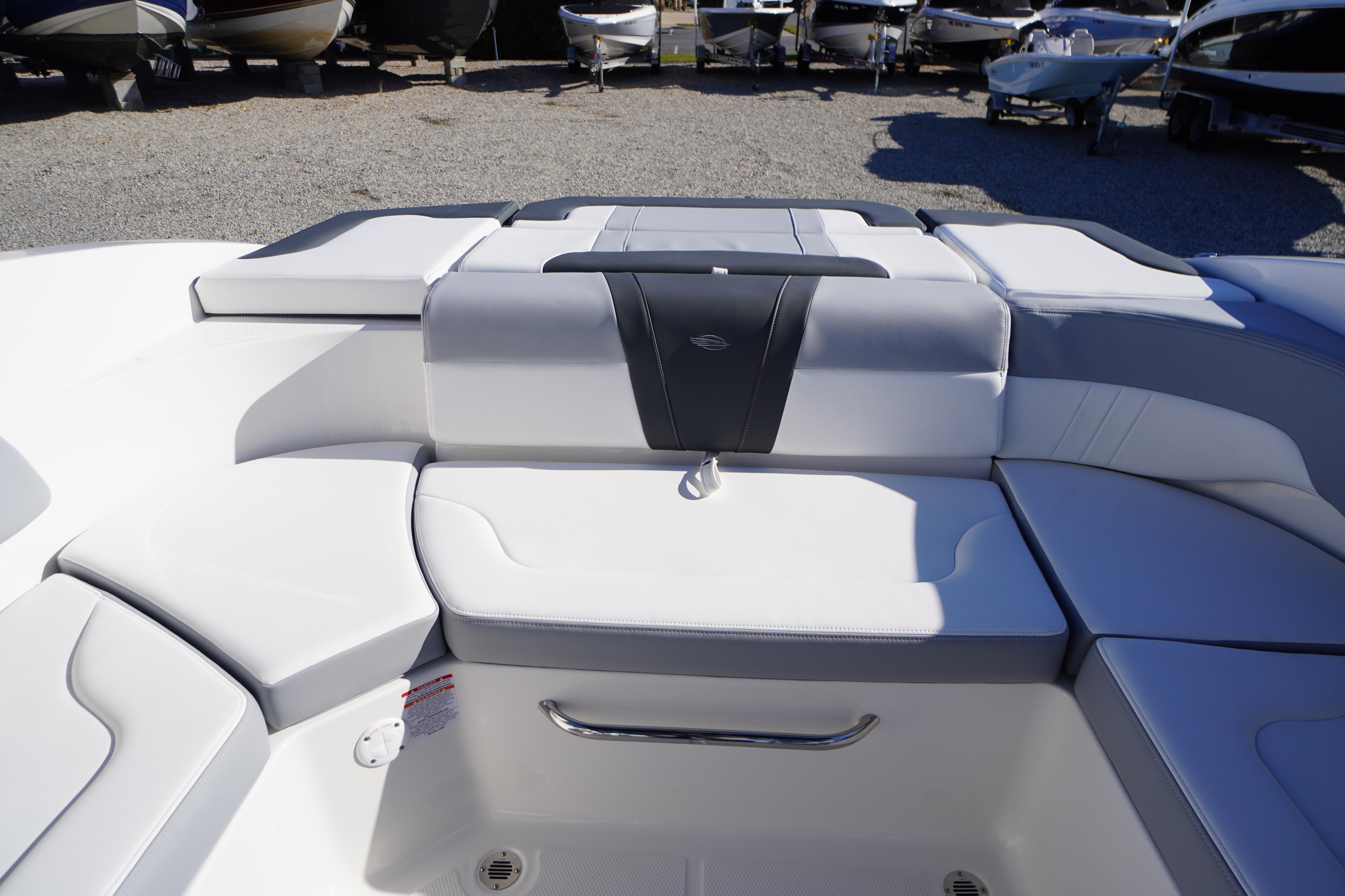 2026 Chaparral 23 SSi boat interior with white seating and storage compartment.
