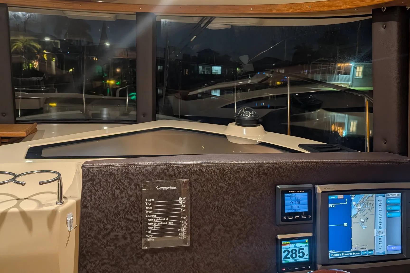 2015 Ranger Tugs R-29 S helm with navigation screens and compass at night.
