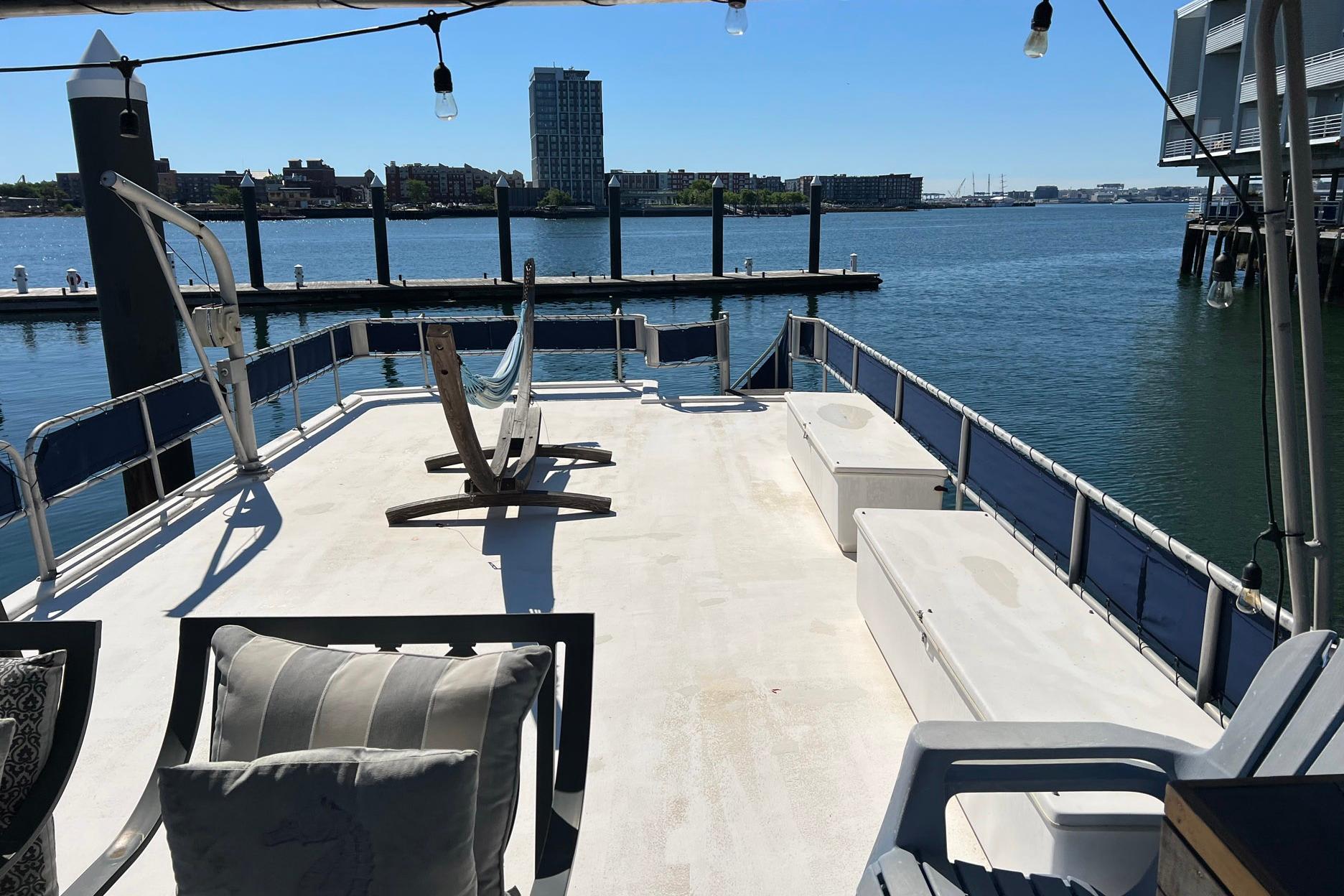 Sunny deck of a 1993 Sumerset houseboat with waterfront view.