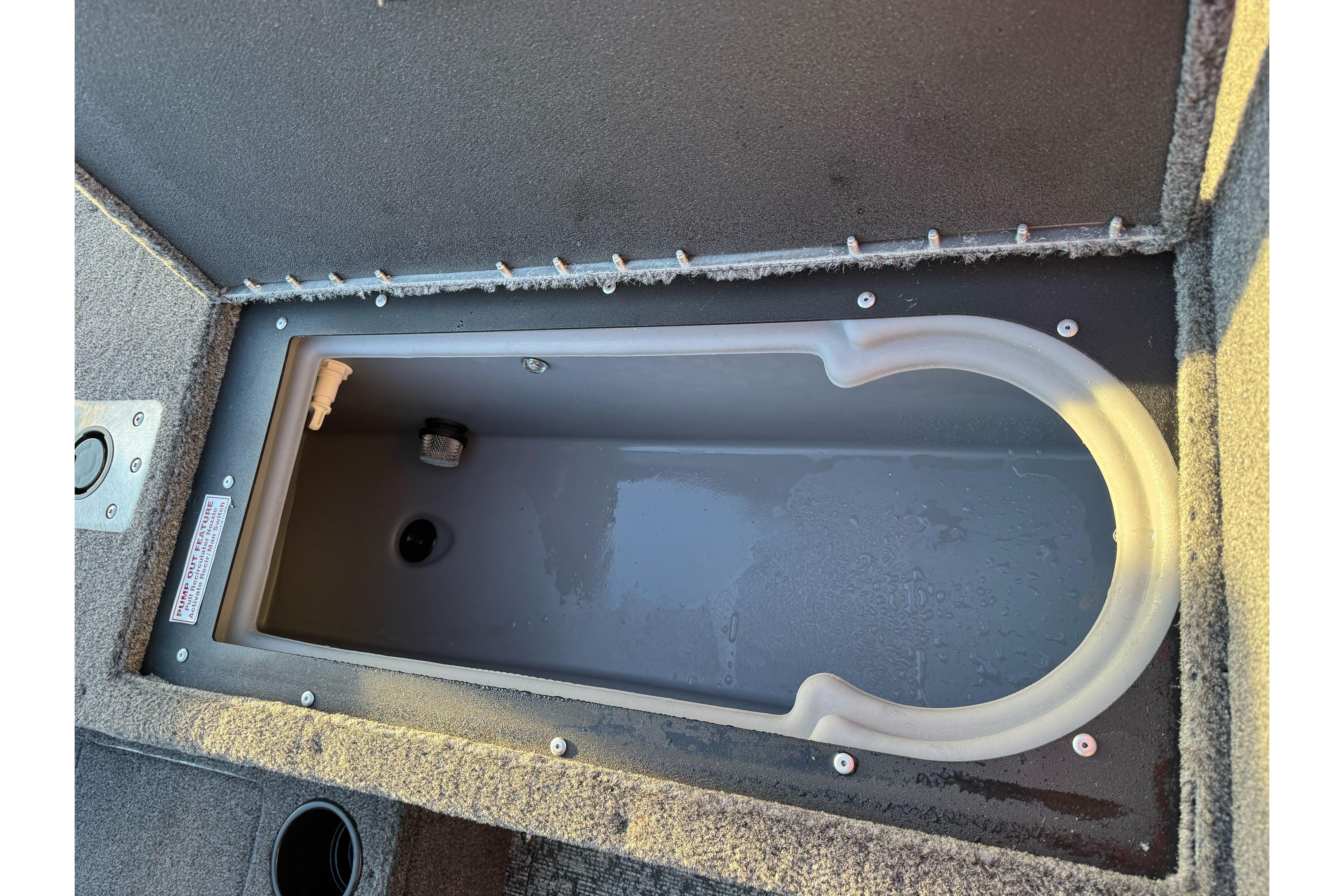 2026 Tracker Targa V-18 WT boat storage compartment, open and empty.