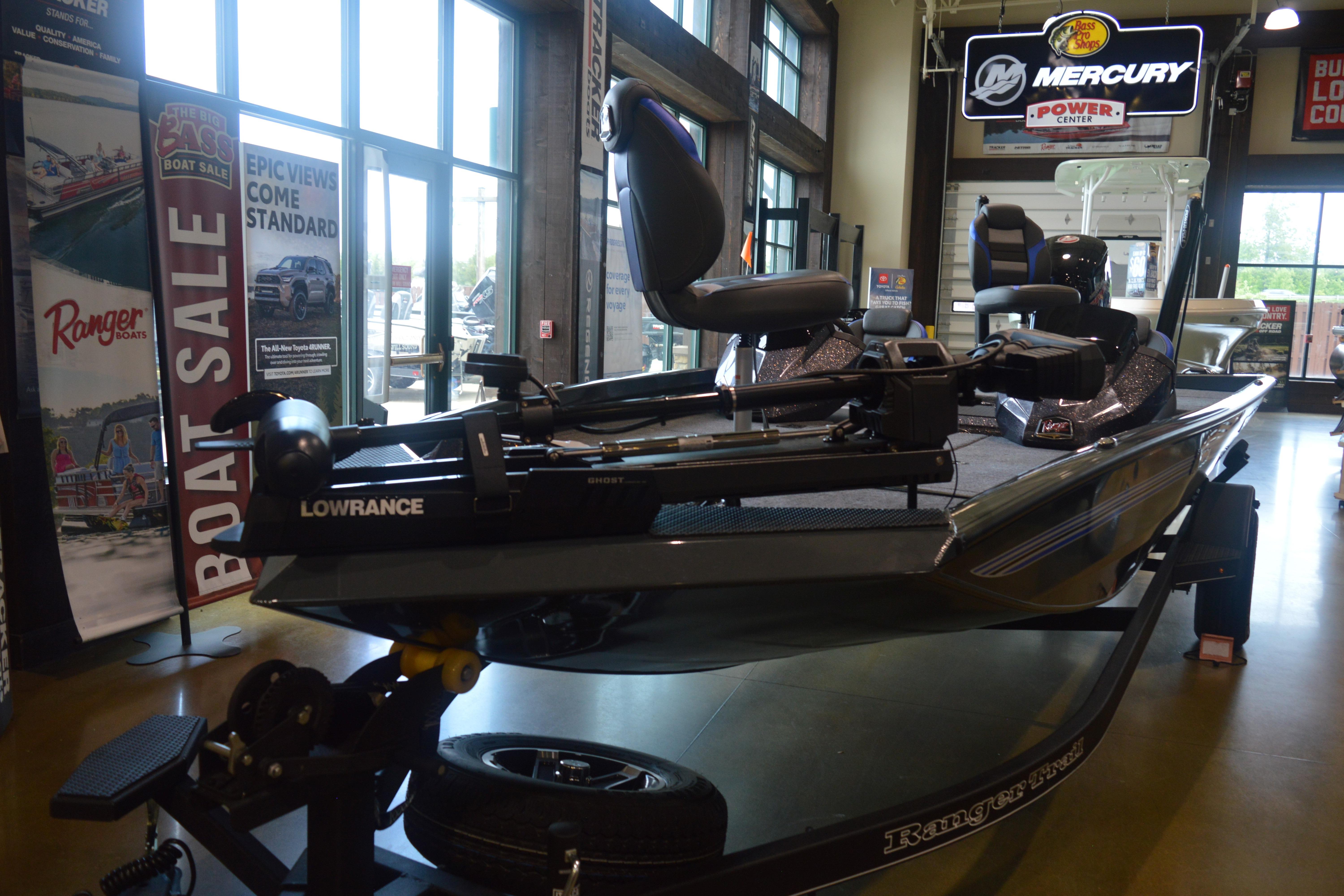 2026 Ranger RT188P boat displayed indoors with Lowrance equipment and promotional banners.
