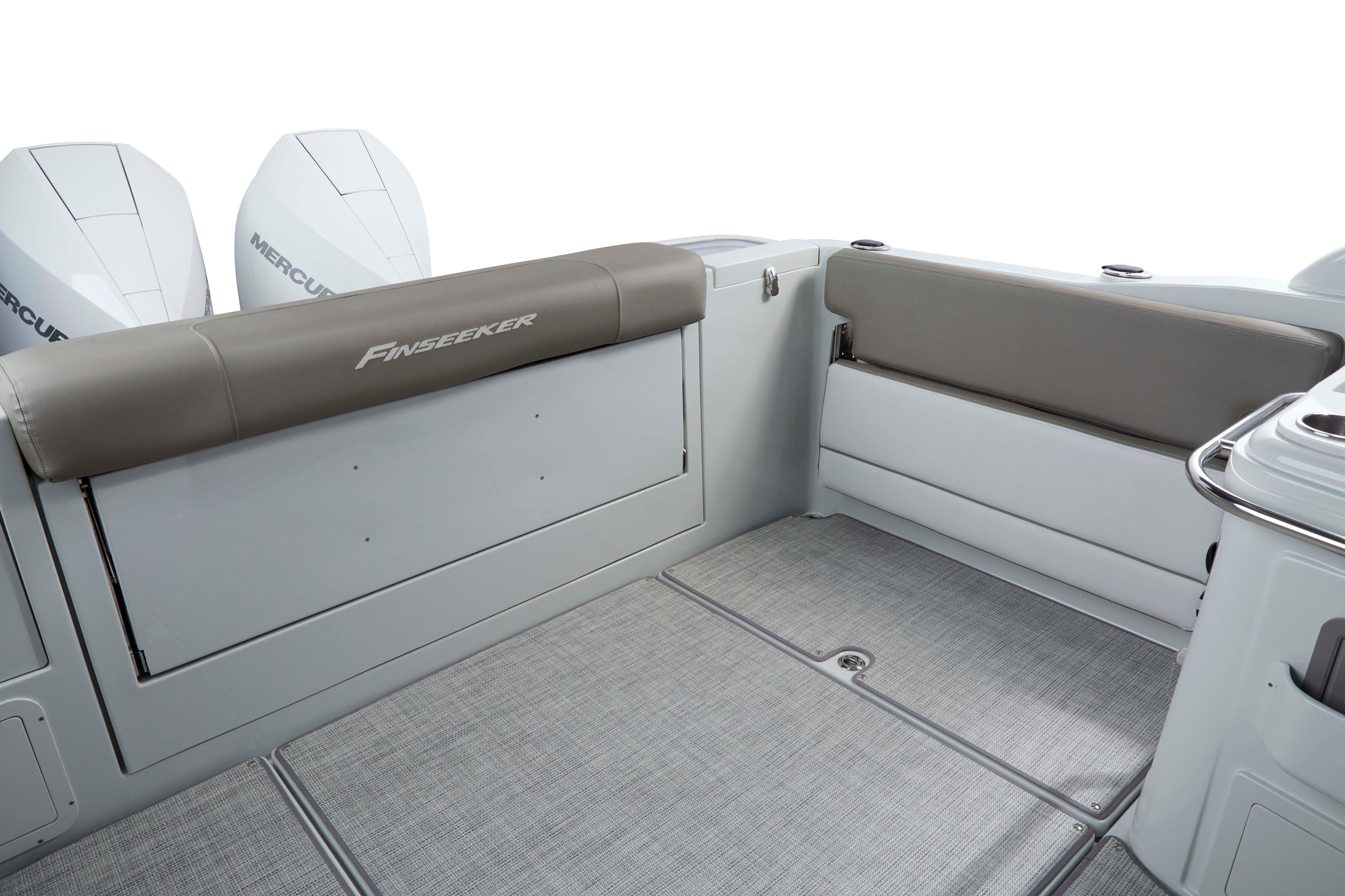 2024 Finseeker 280 DC boat interior with cushioned seating and dual Mercury engines.