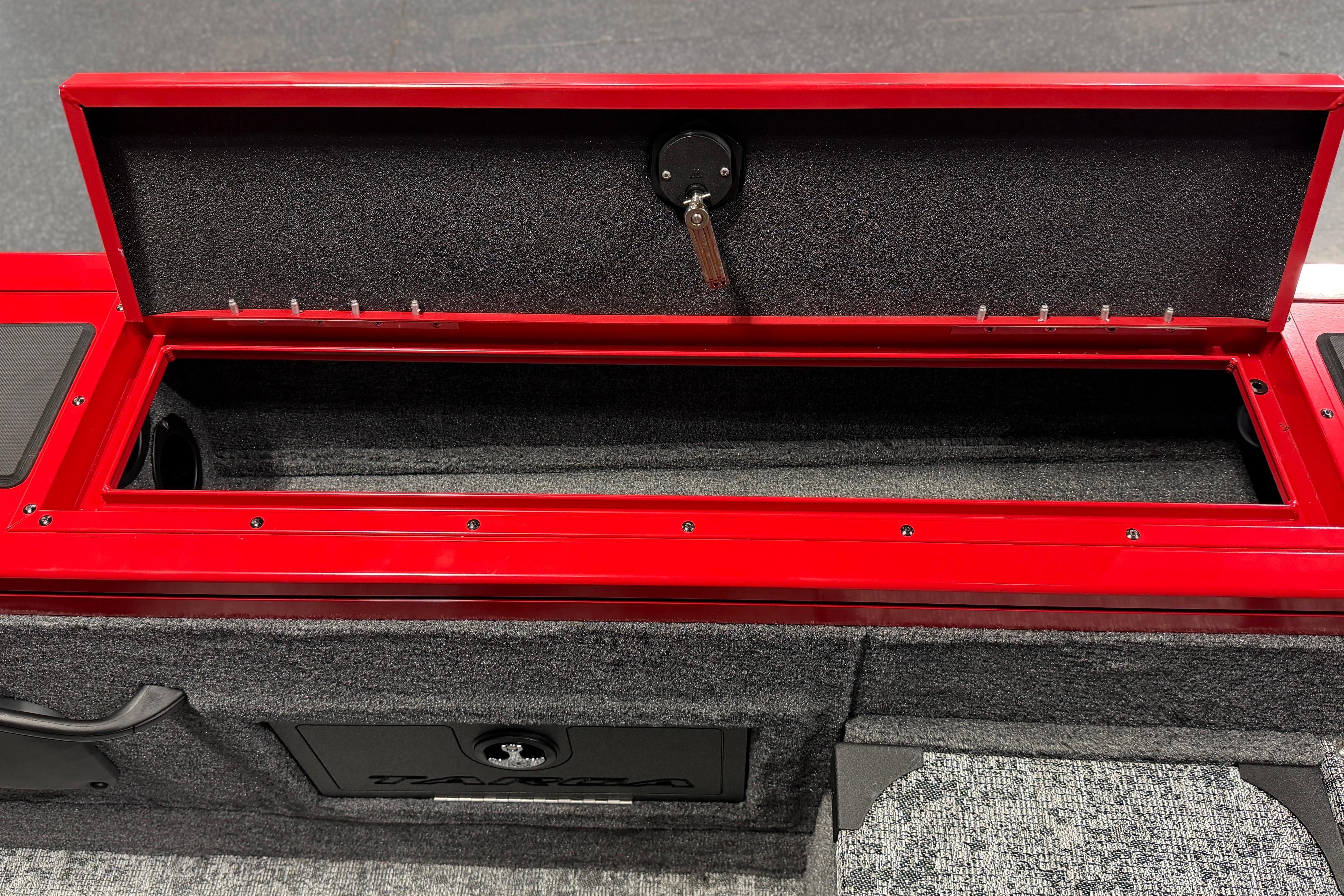 Open storage compartment in 2026 Tracker Targa V-18 Combo boat, featuring red and gray design.