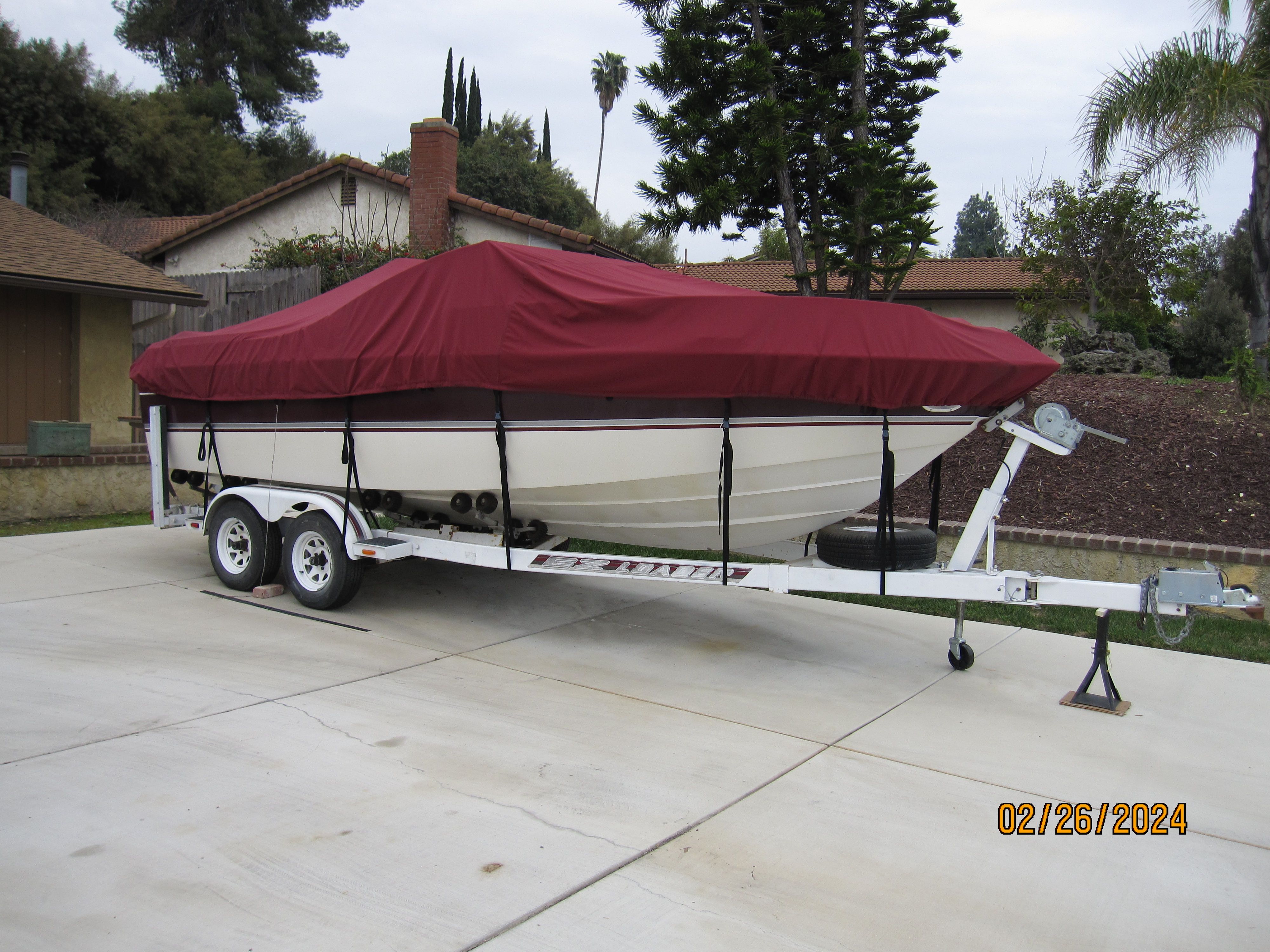 1990 Cobalt Bowrider Classic boat with red cover on trailer.