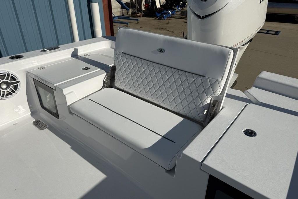2026 Sportsman Masters 247OE Bay Boat with white cushioned seating and storage compartments.