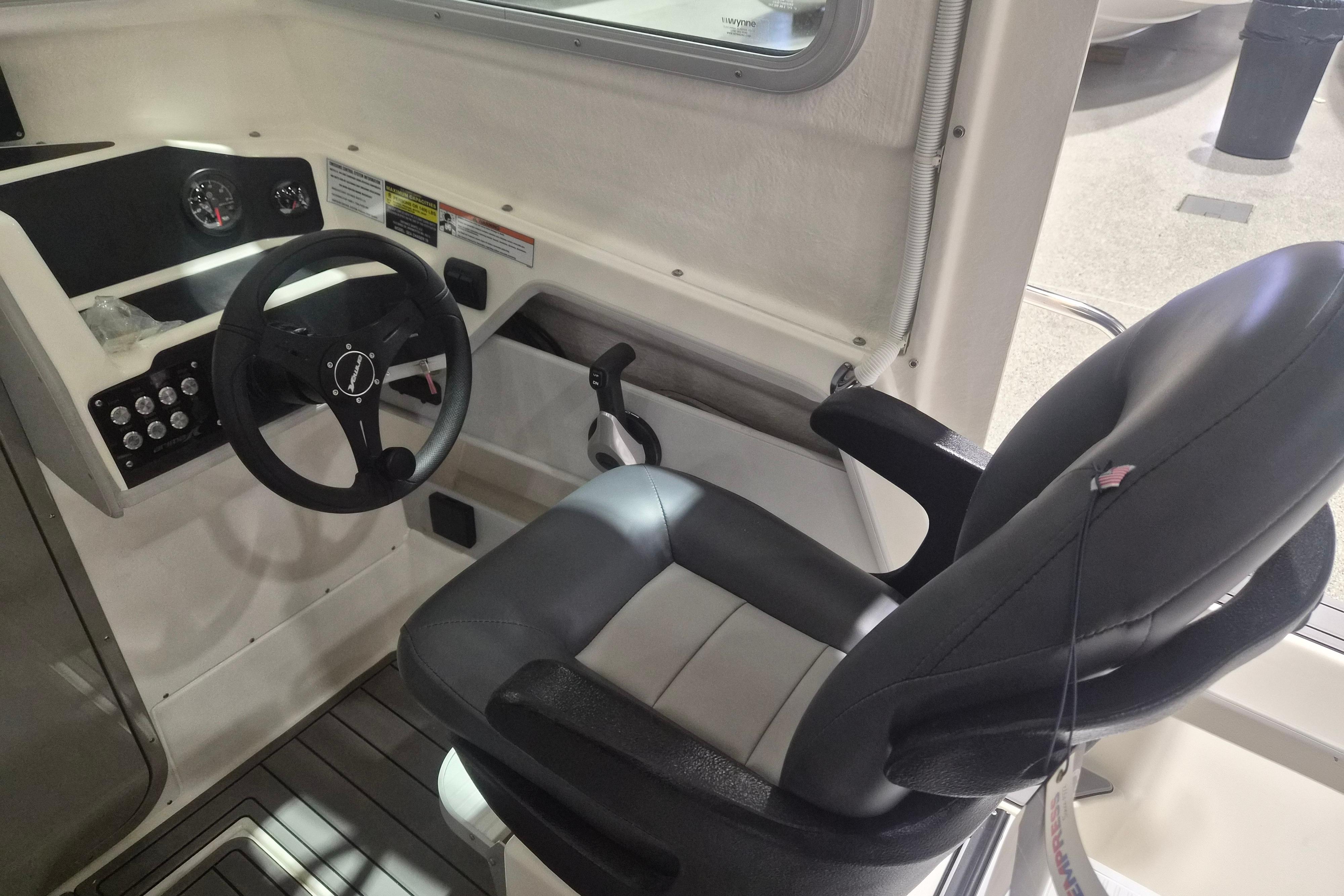 Interior of 2026 Arima Sea Chaser 19 Yellowtail Edition, featuring steering wheel and captain's chair.