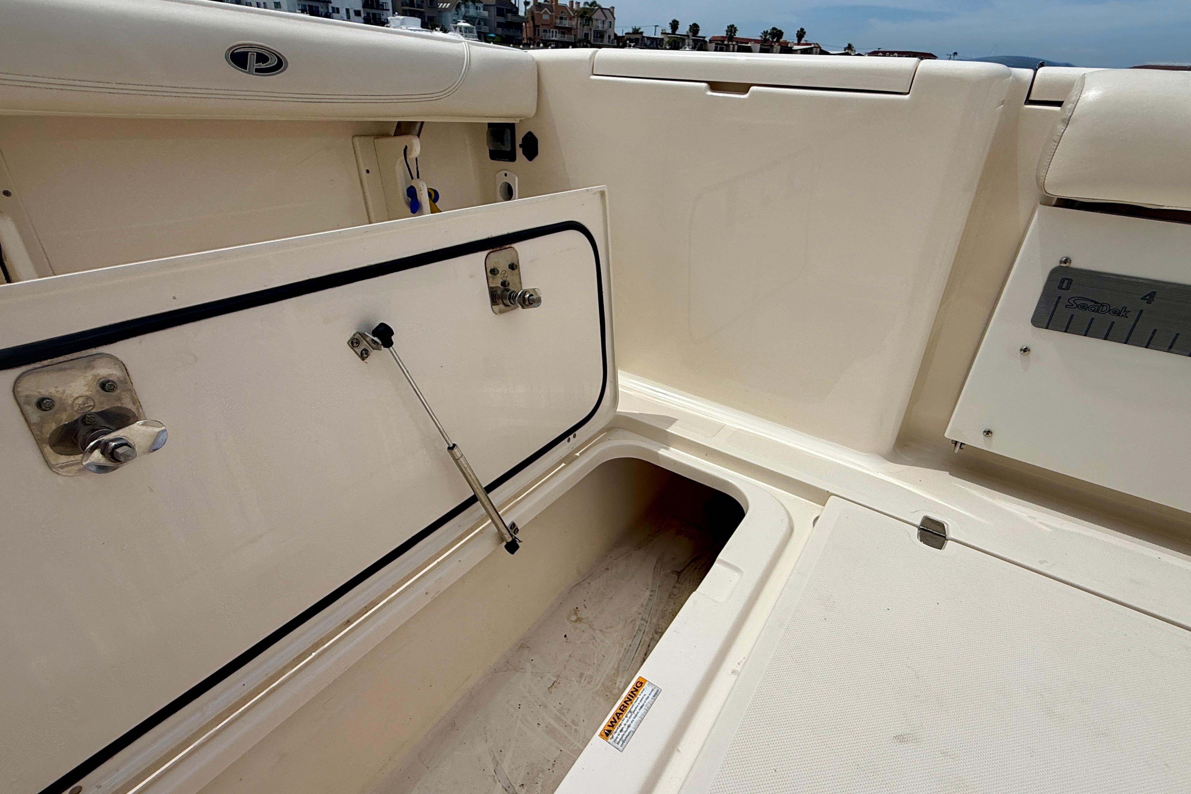 2012 Pursuit OS 345 Offshore boat storage compartment with open hatch and hydraulic support.