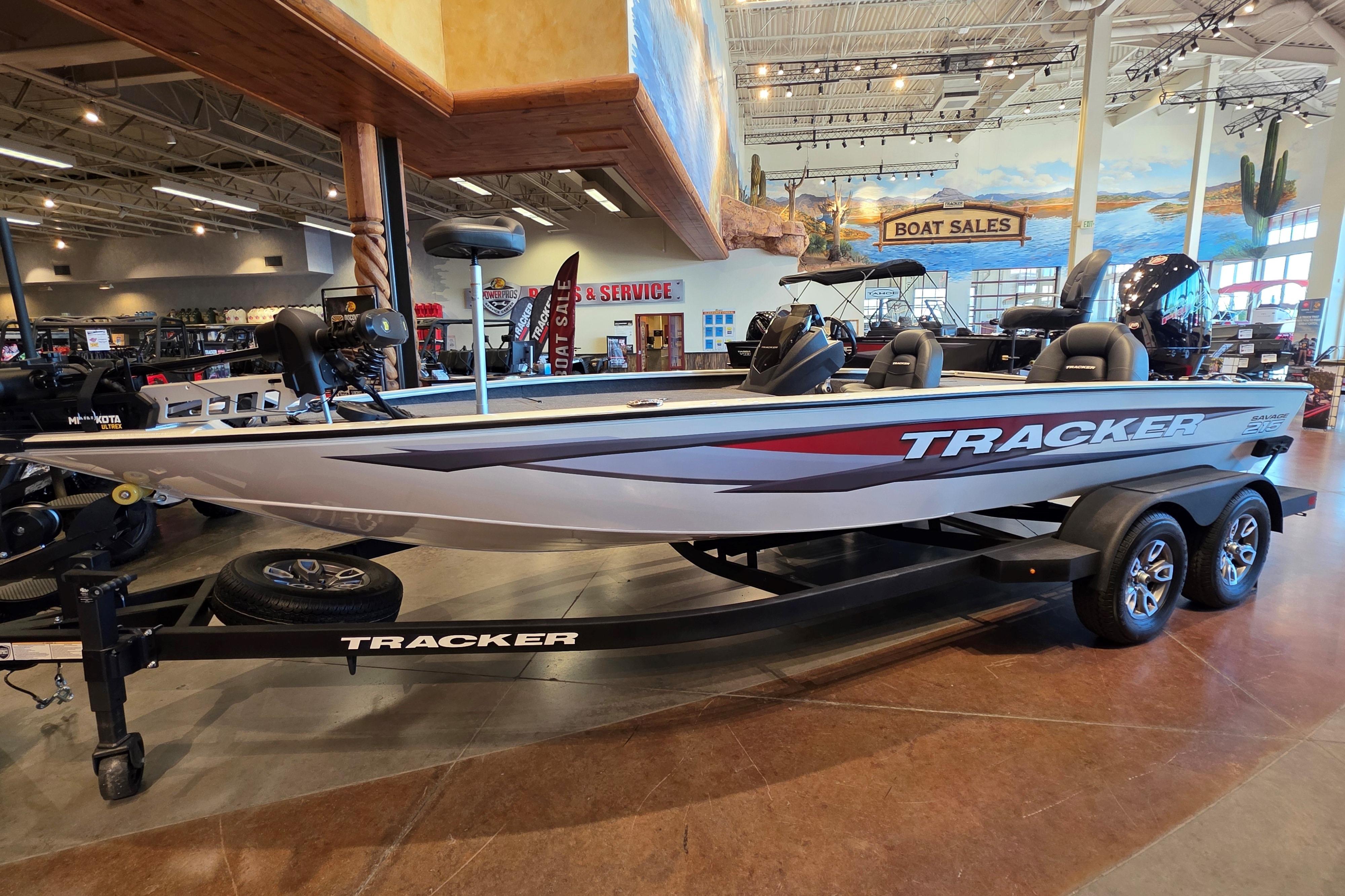2026 Tracker Savage 215 boat displayed in showroom with sleek design and modern features.