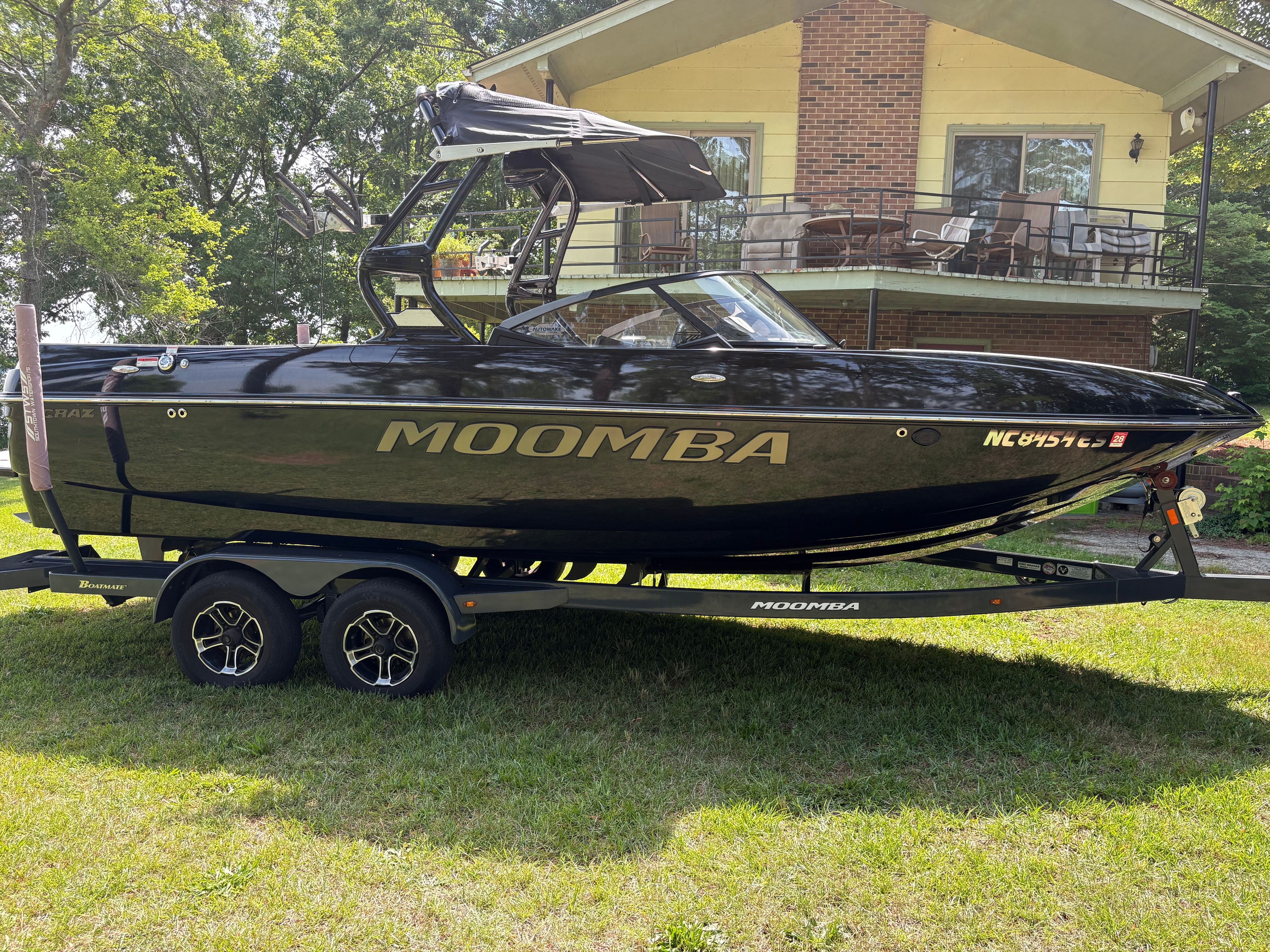 2021 Moomba Craz boat on trailer in front of house.