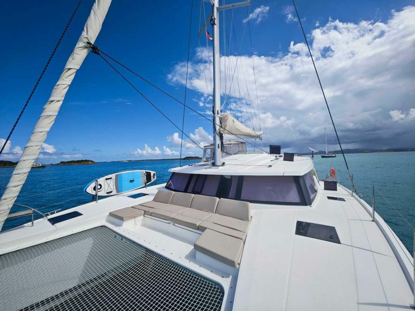 2020 Fountaine Pajot Astrea 42 catamaran on tranquil blue sea under clear sky.