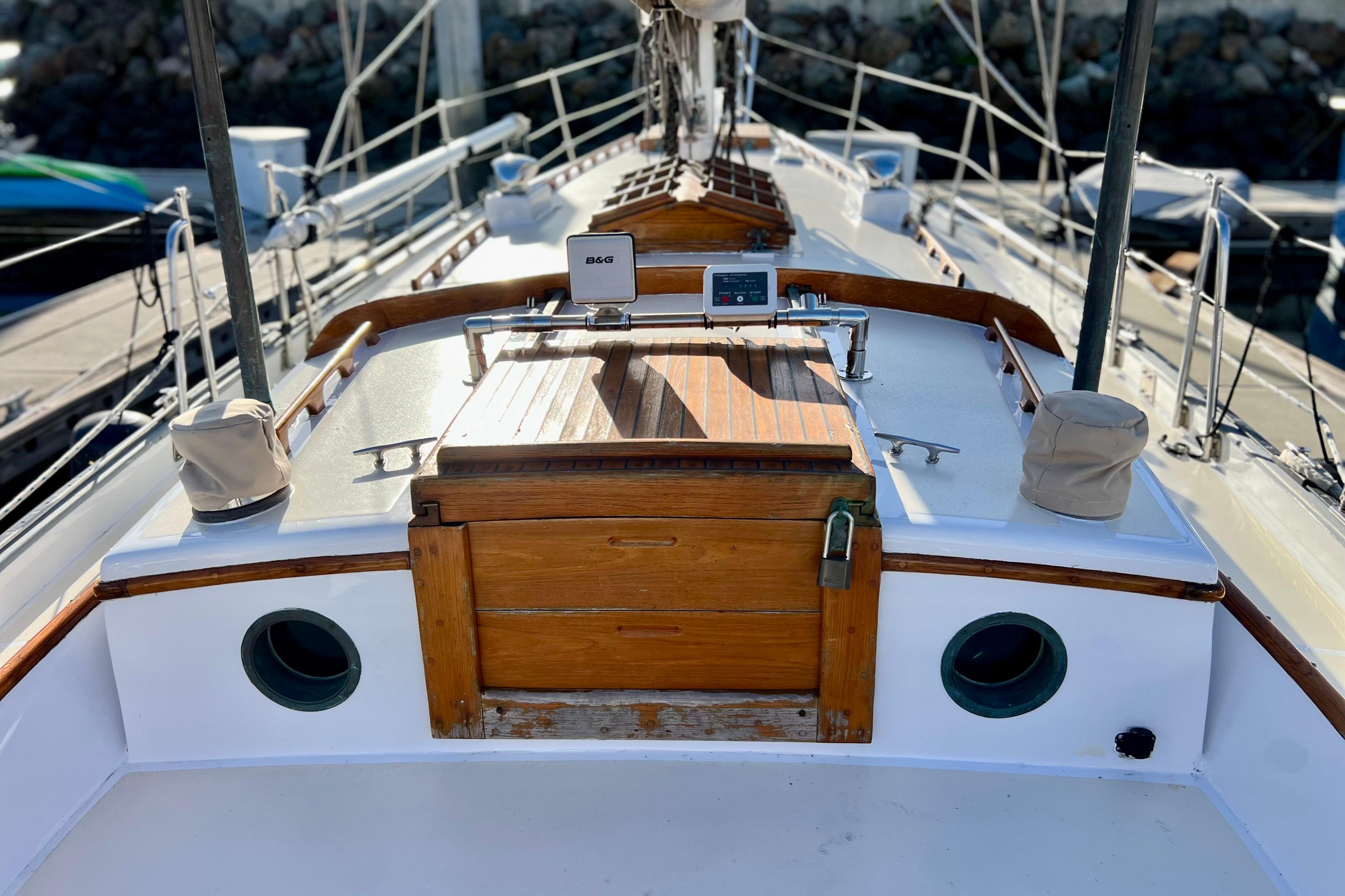 1975 Cape George 36 sailboat deck with wooden hatch and navigation equipment.