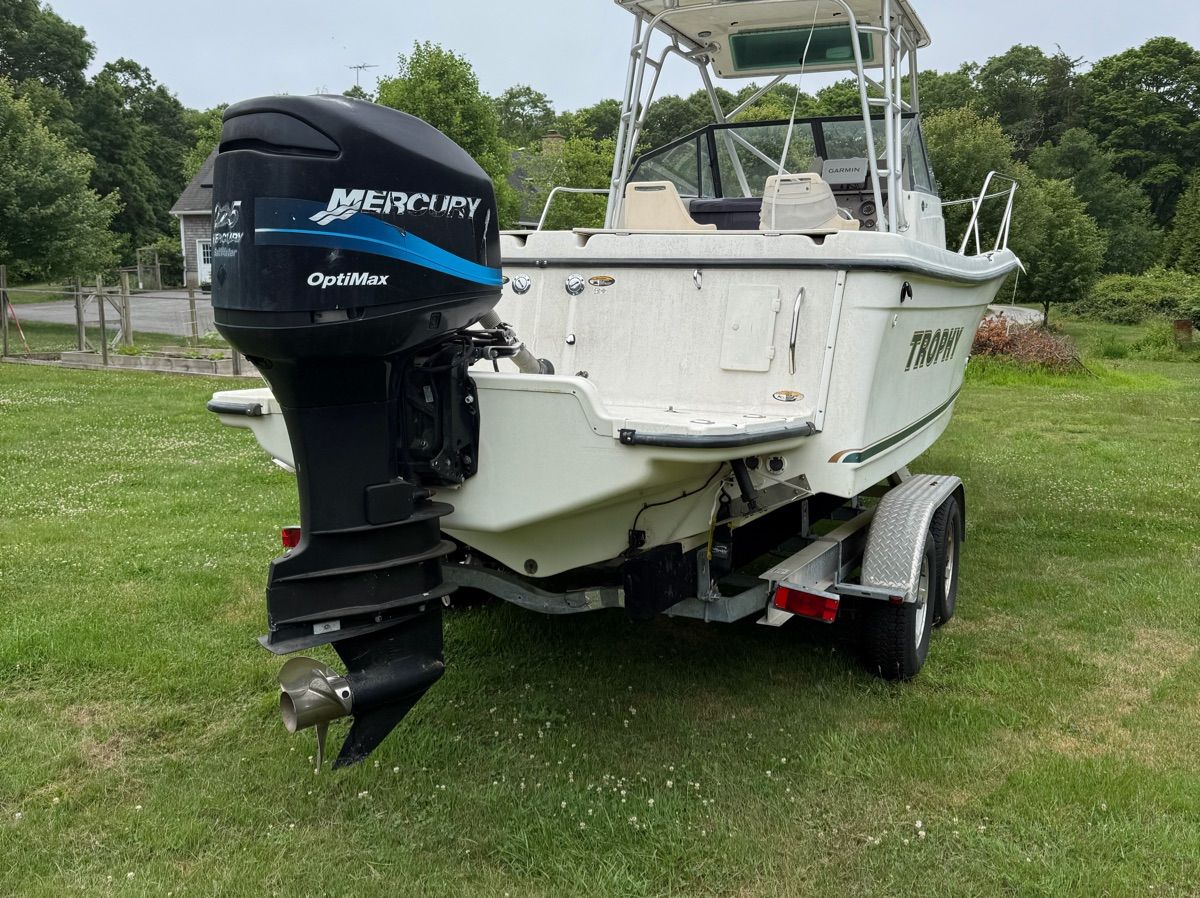 A 2001 Trophy 2509 Walkaround on a trailer, featuring a Mercury outboard motor.