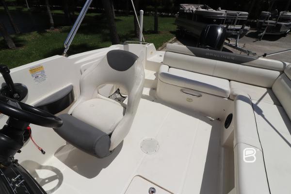 2018 Bayliner 210 DB boat interior with seating and steering wheel.