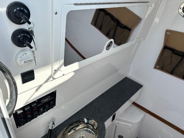 Interior view of 2025 Southport 33 DC boat with control panel and storage.