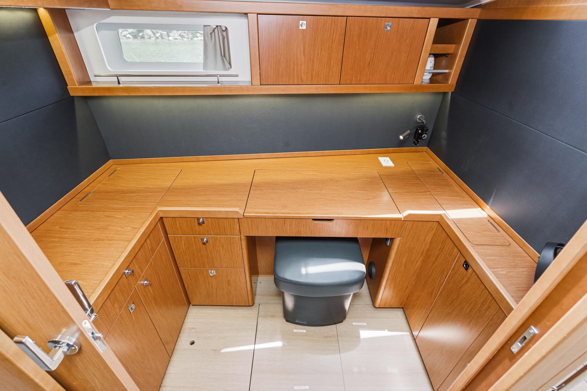 Interior of 2017 Beneteau Sense 50 yacht with wooden cabinetry and seating.