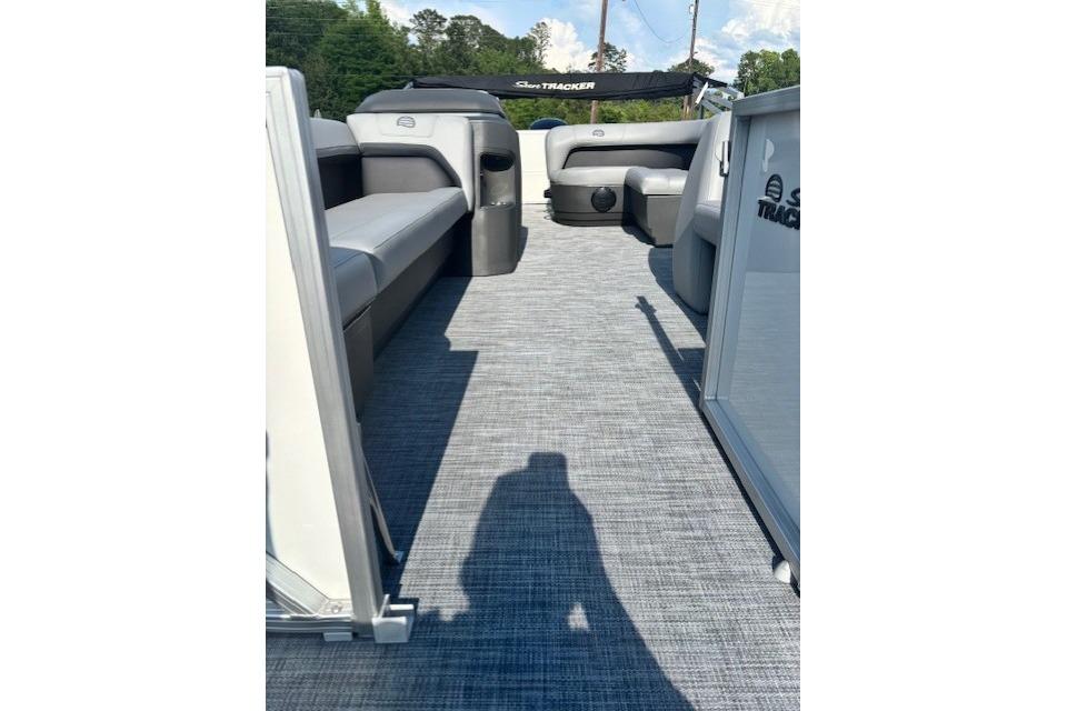 2026 Sun Tracker Party Barge 18 DLX interior with gray seating and open deck.