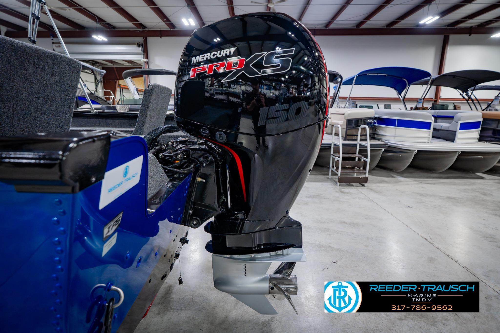 2026 Lund 1875 Impact XS boat with Mercury Pro XS 150 engine in showroom.