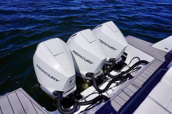 Triple Mercury outboard engines on a 2020 Cruisers Yachts 38 GLS OB, docked on water.