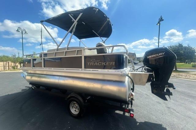 2026 Sun Tracker Bass Buggy 18 DLX pontoon boat with Mercury outboard motor.