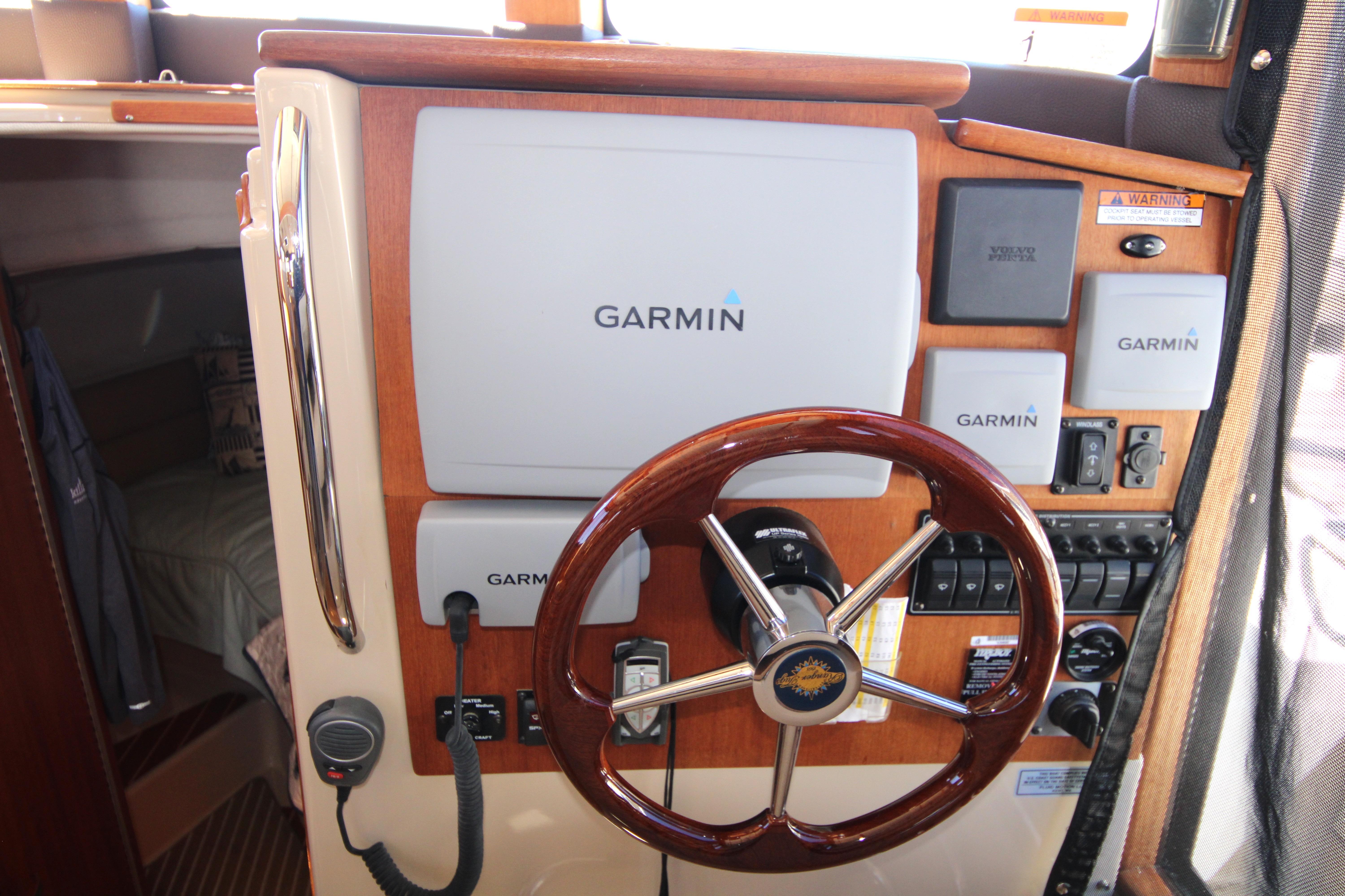 2013 Ranger Tugs R-31 CB helm with Garmin navigation system and wooden steering wheel.
