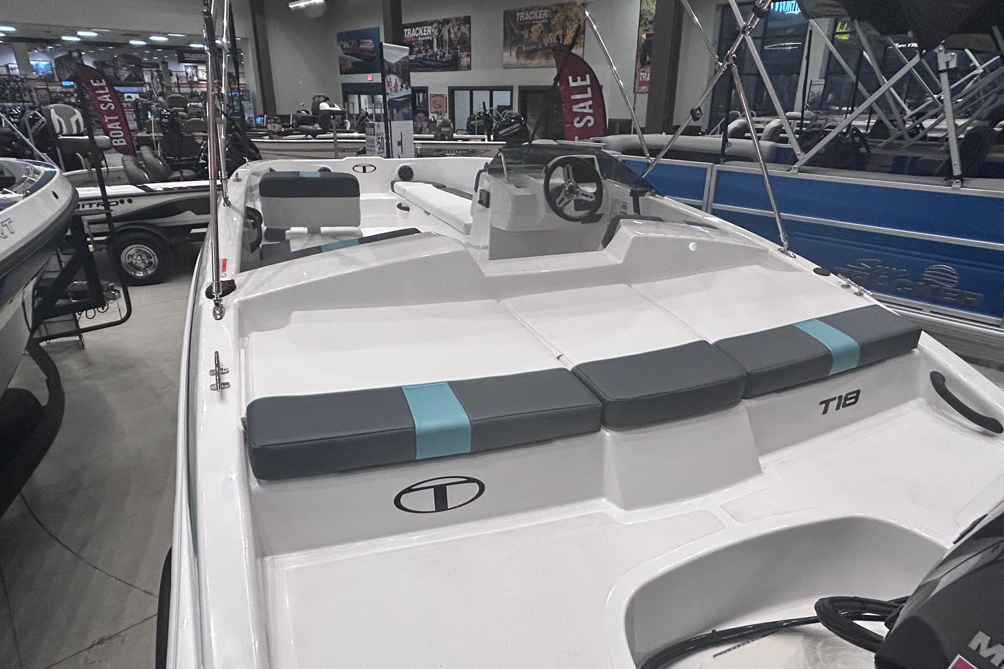 2026 Tahoe T18 boat on display in showroom, featuring sleek design and comfortable seating.