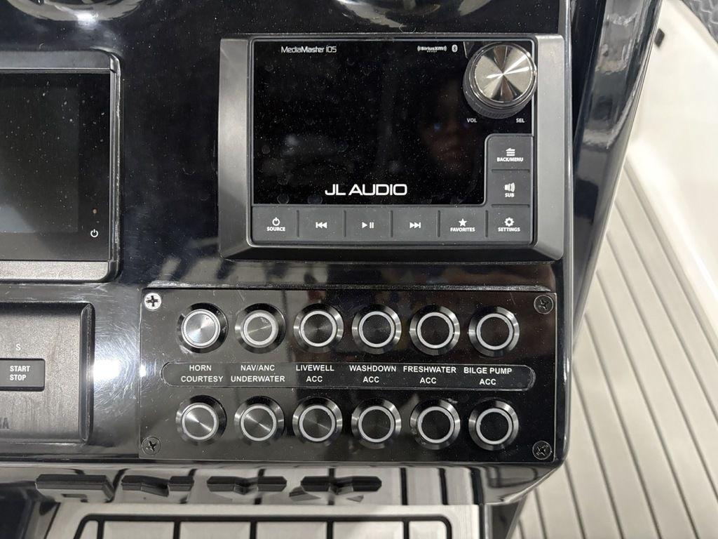 Control panel of 2026 Tidewater 2700 CB boat with JL Audio system and switches.