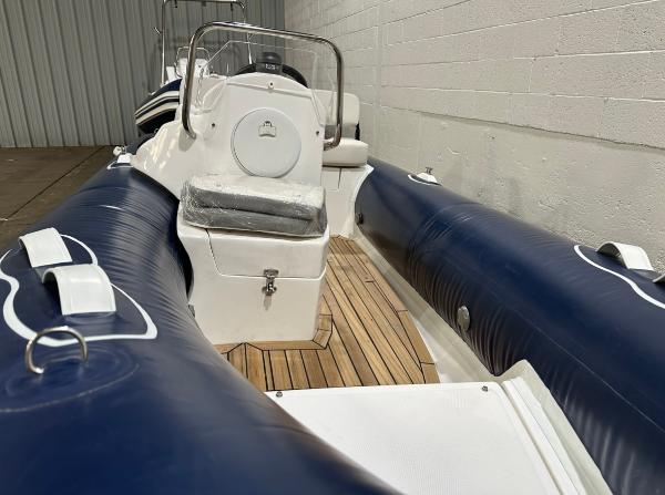 2024 Apex A-13 Deluxe Tender with blue inflatable sides and wooden deck.