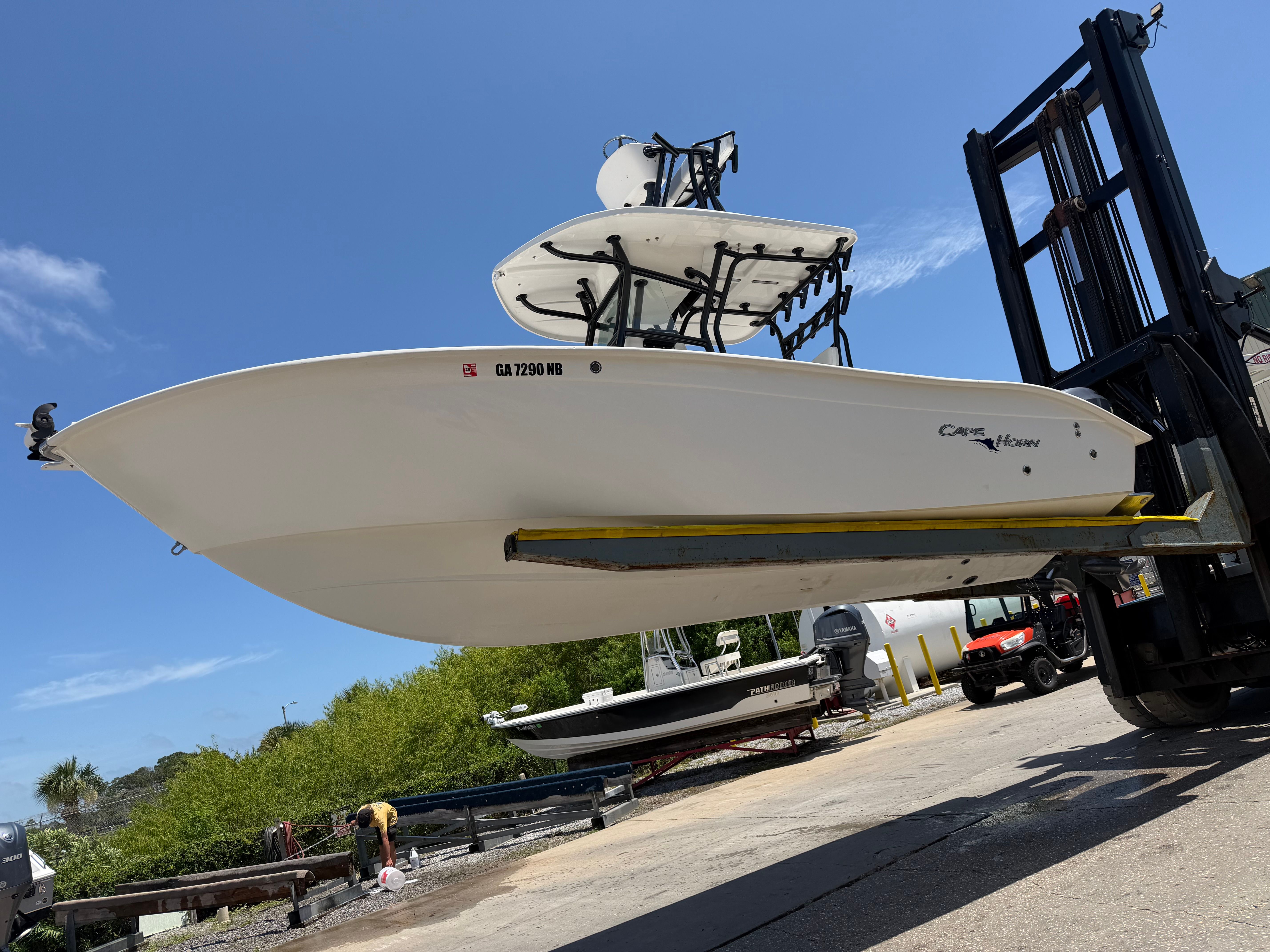 A 2014 Cape Horn 24XS boat being lifted by a forklift.