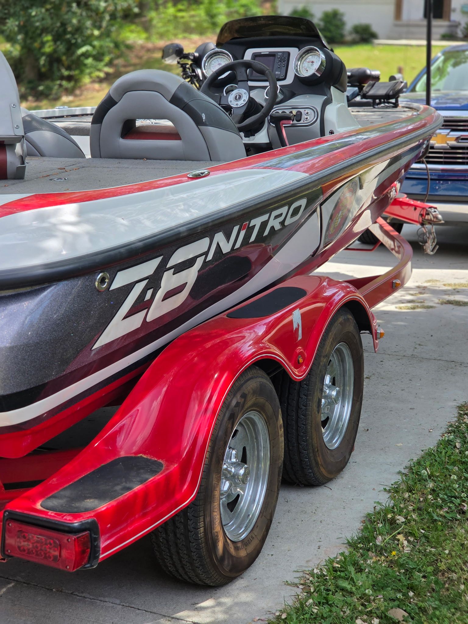 A red 2010 Nitro Z-8 boat is on a trailer.