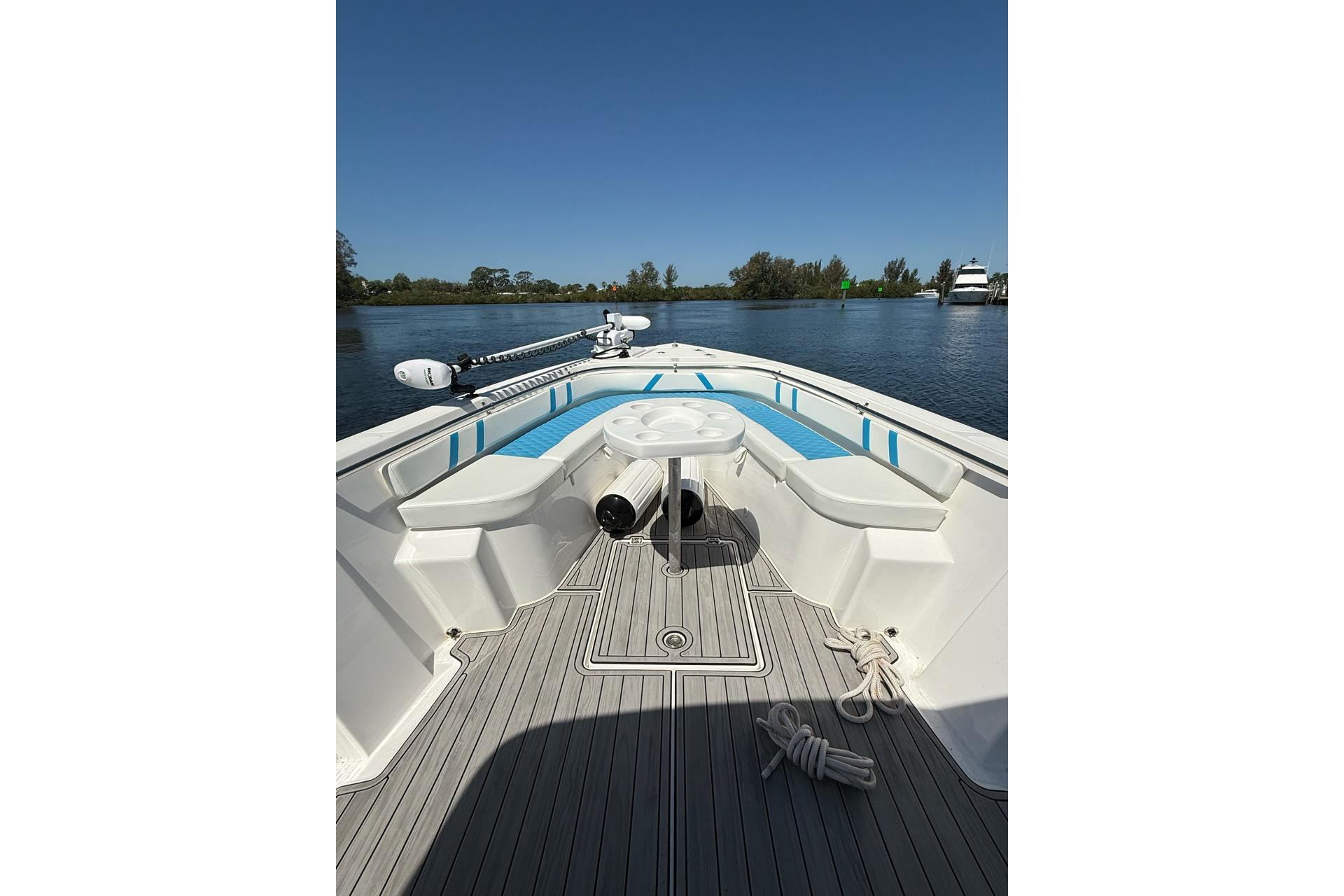 2021 Custom Infusion 34 CC boat interior with seating and table on calm water.