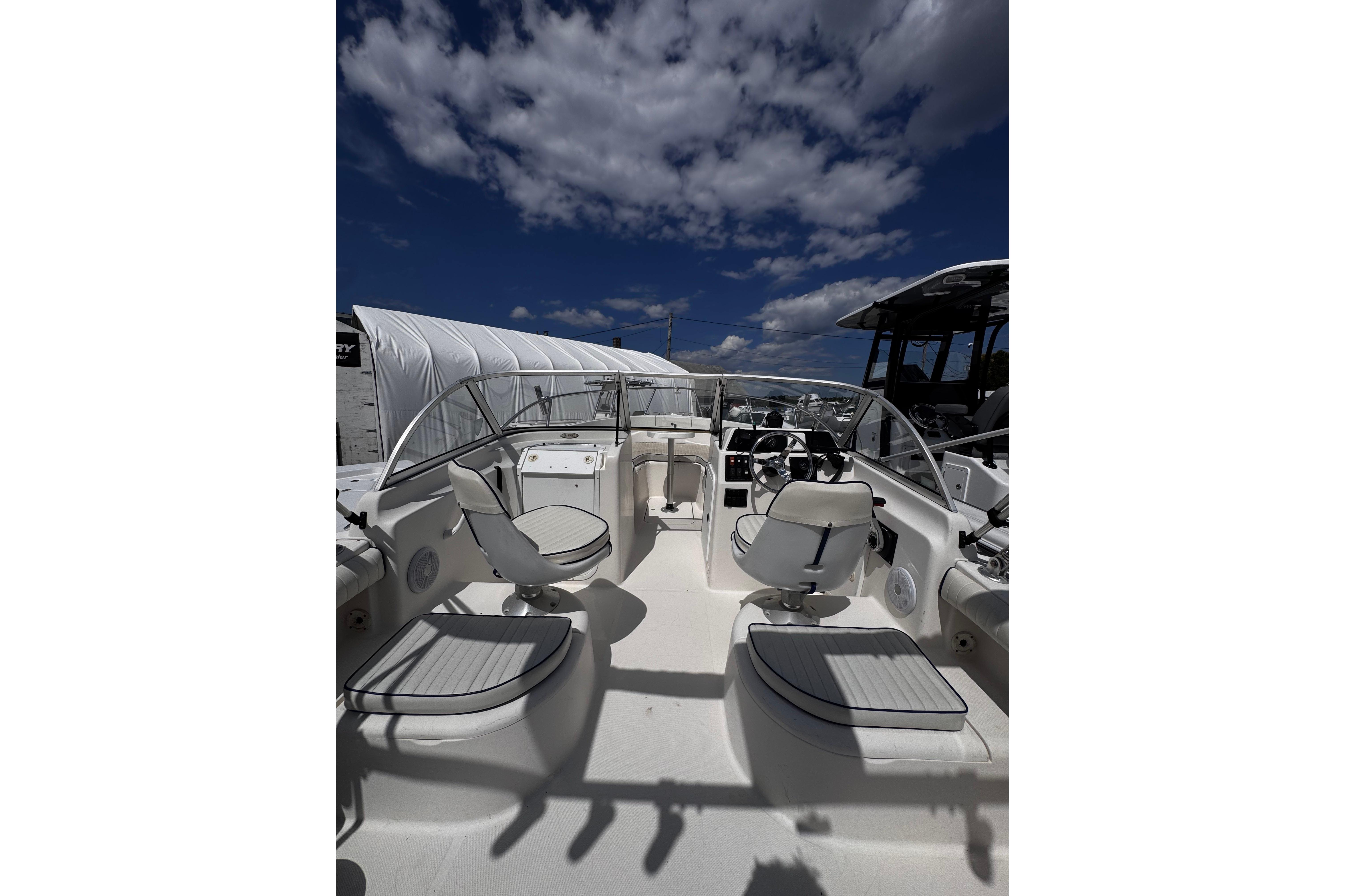 2003 Palm Beach 2200 Dual Console boat interior under a partly cloudy sky.