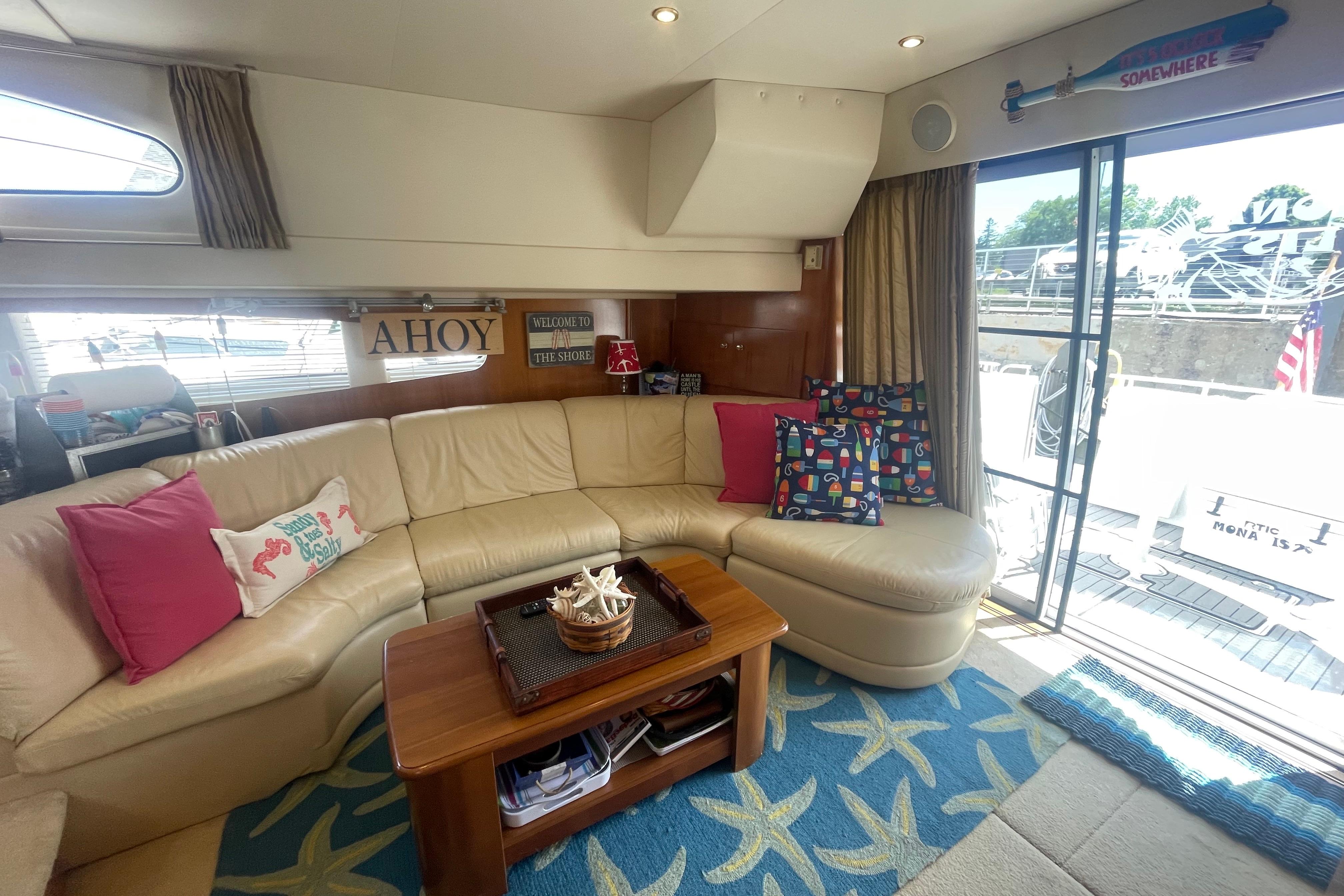 Interior of 2002 Carver 410 Sport Sedan with cozy seating and nautical decor.