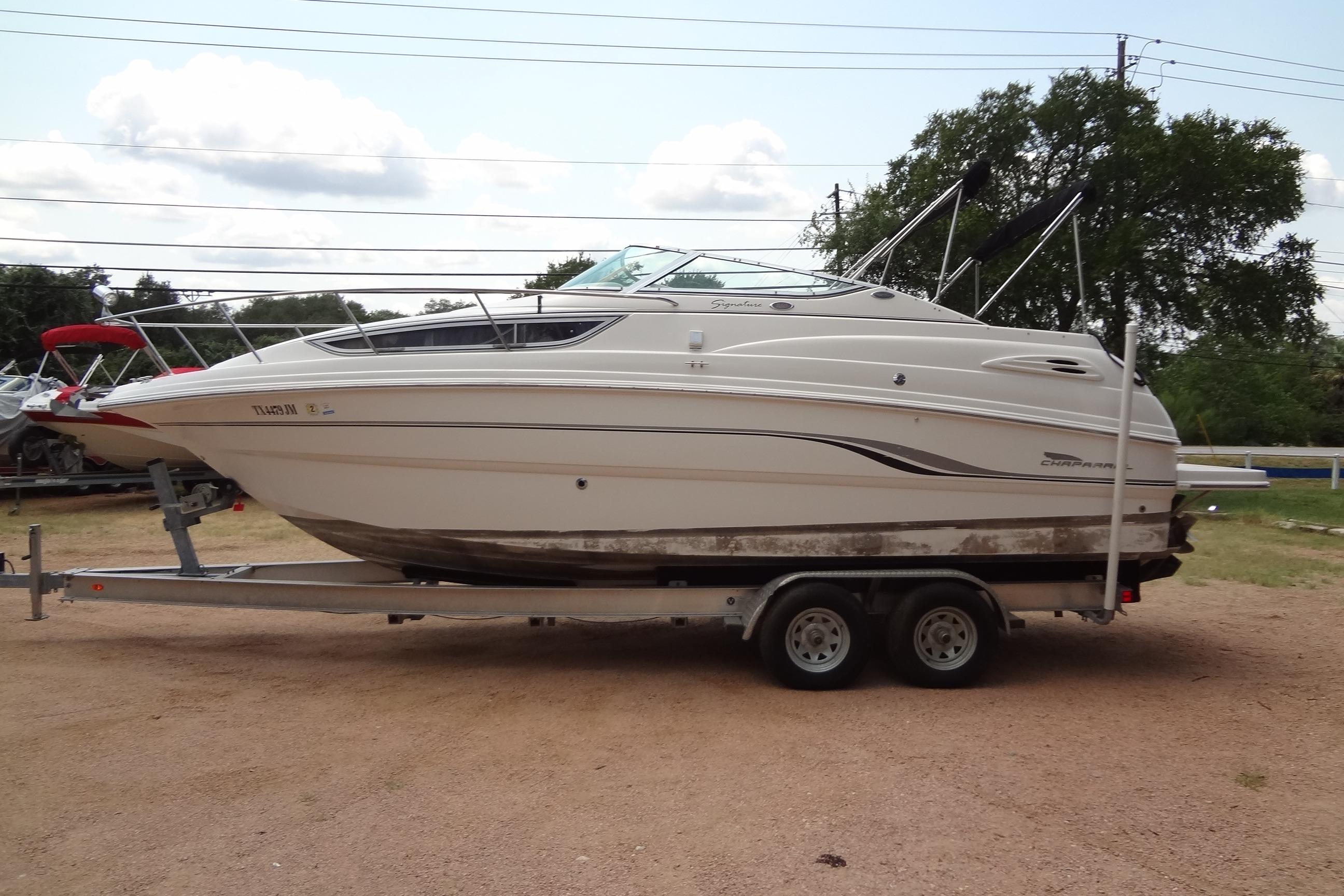 2000 Chaparral Signature 260 boat on trailer, parked outdoors.