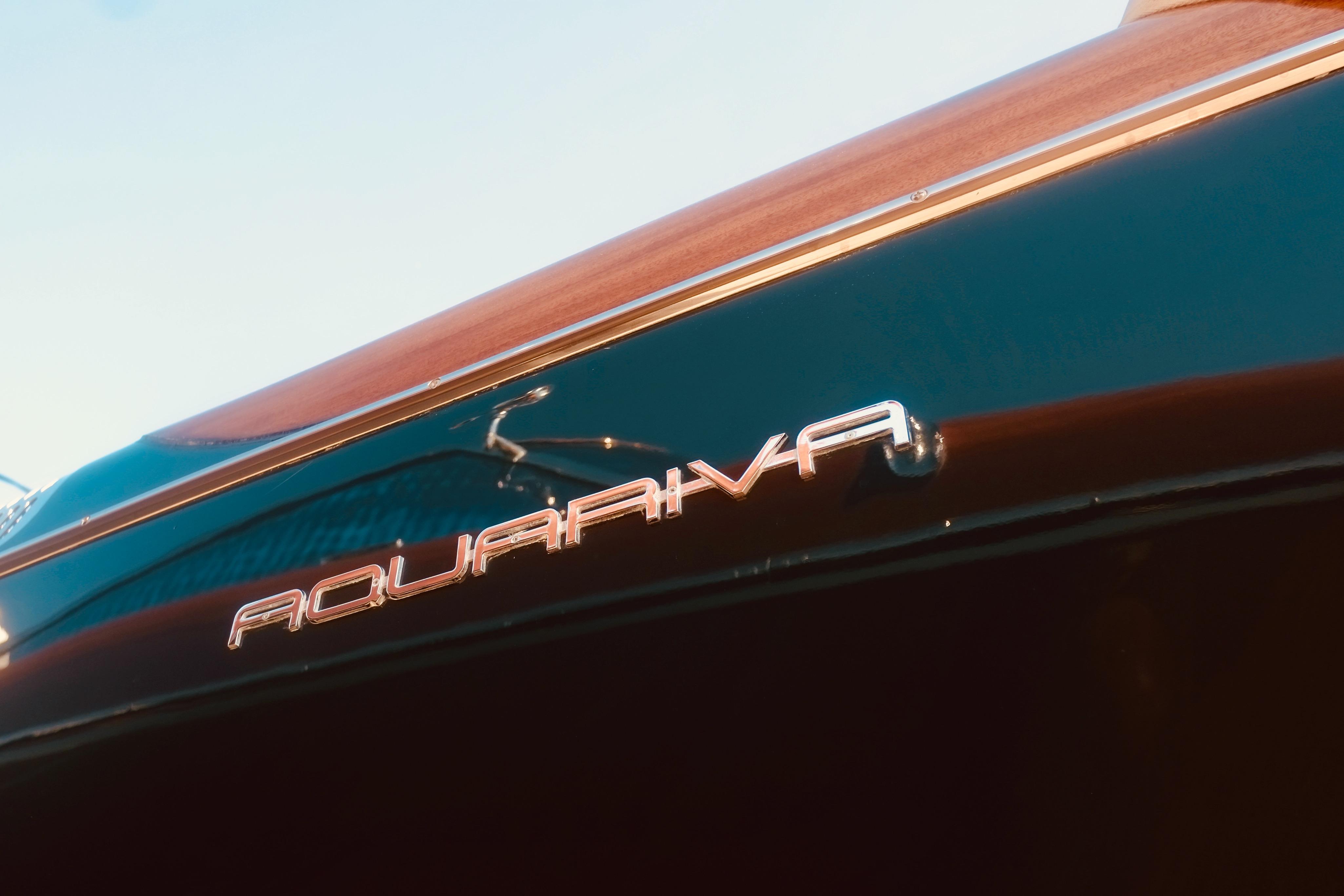 2003 Riva Aquariva 33 boat nameplate on sleek, polished hull.