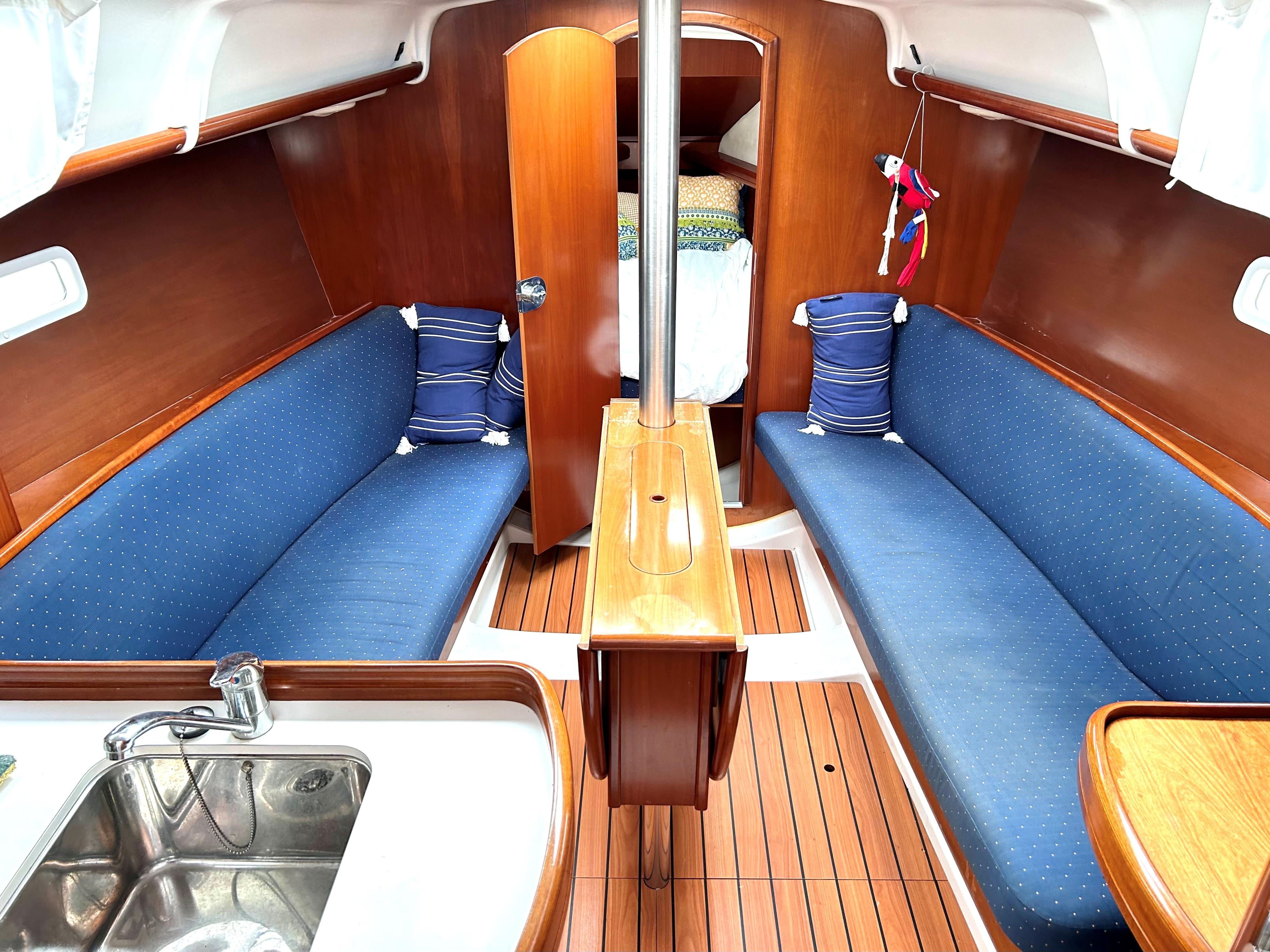 Interior of a 2005 Beneteau 323 yacht with blue upholstery.