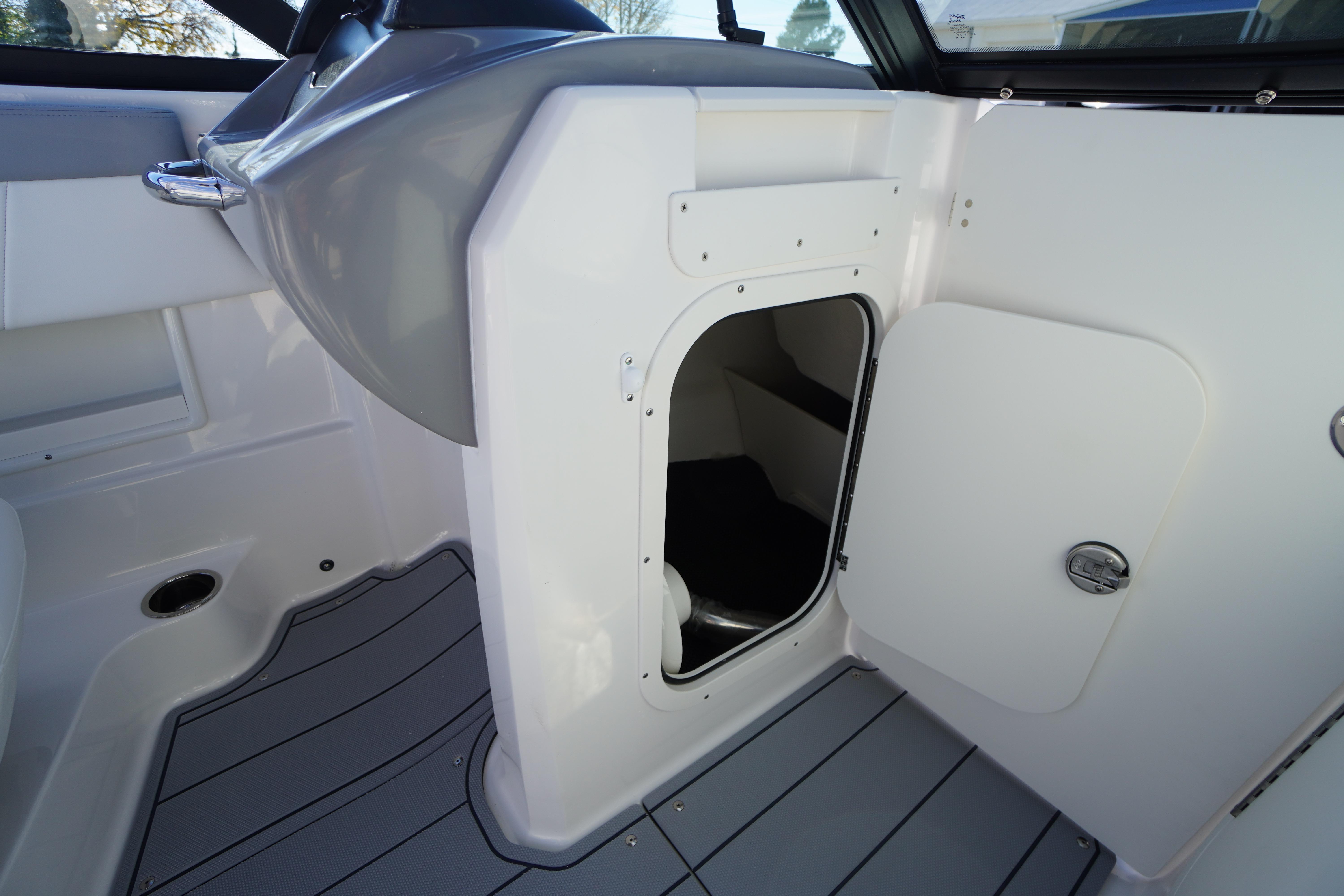 2026 Chaparral 23 SSi OB boat interior with open storage compartment.
