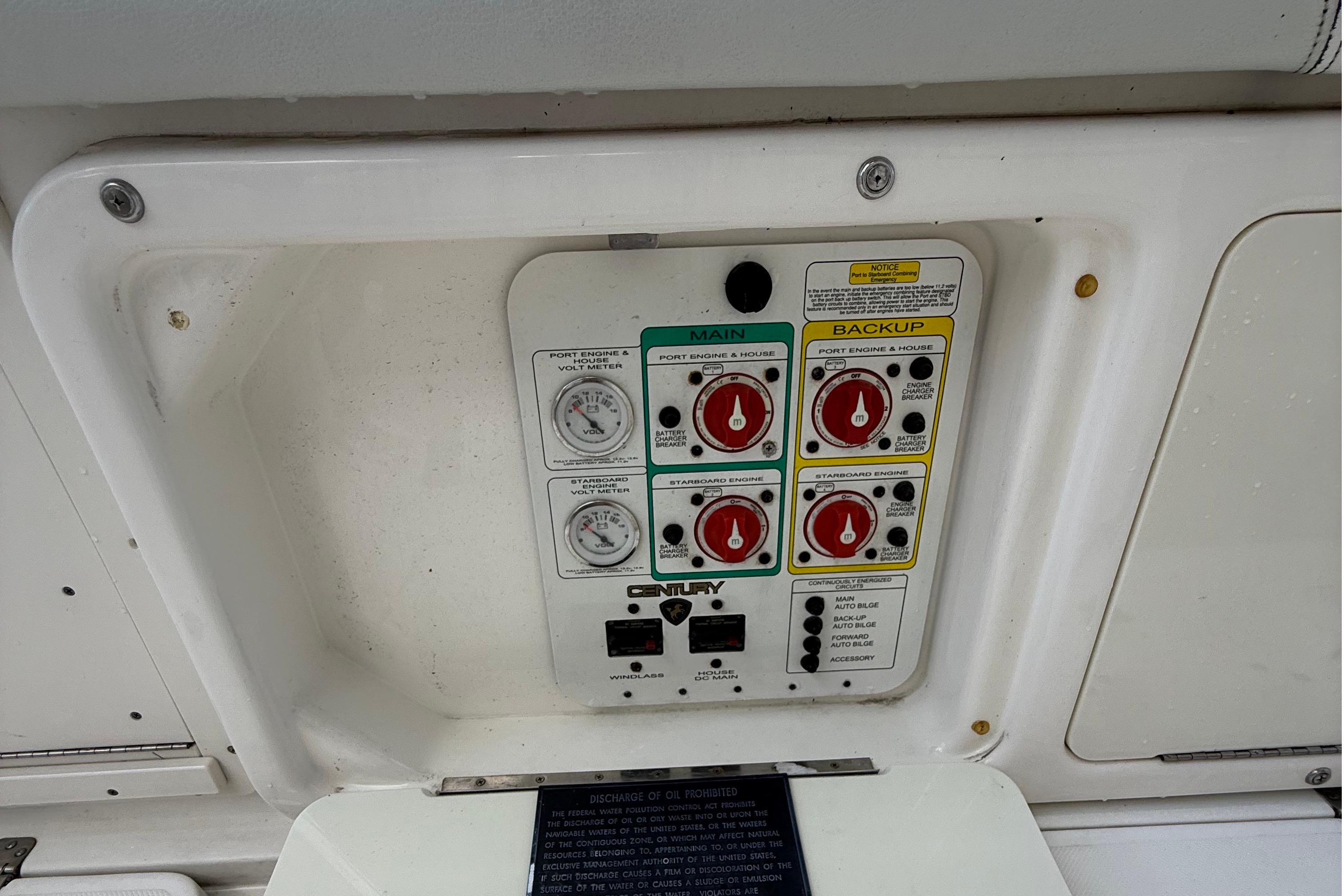 Control panel of a 2008 Century 2901 Center Console boat, featuring main and backup switches.