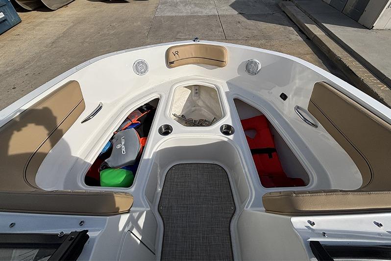 2023 Bayliner VR5 Bowrider OB interior with tan seating and storage compartments.