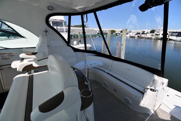2010 Cruisers Yachts 390 Sports Coupe interior with white seating and marina view.