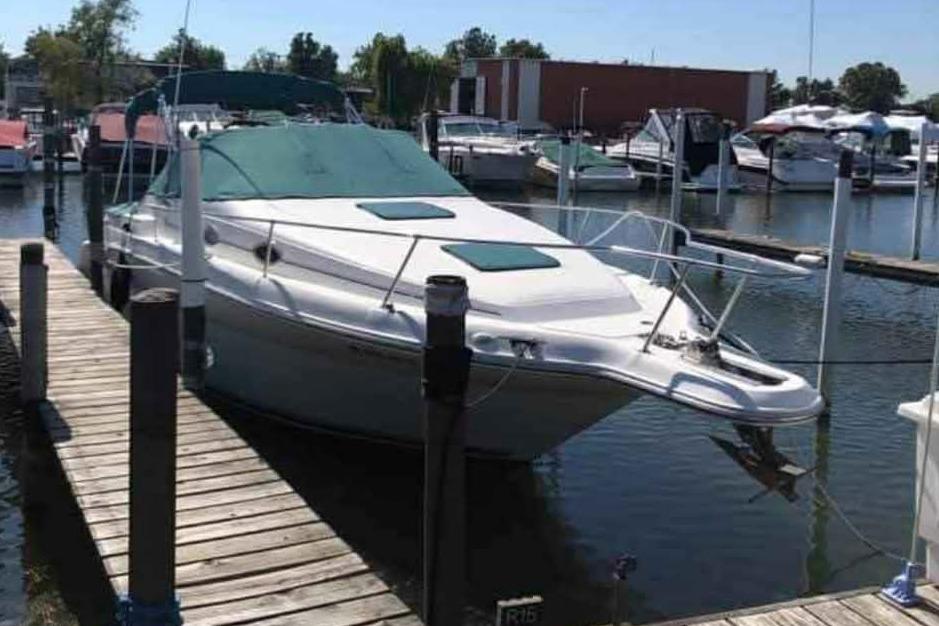 1996 Sea Ray 270 Sundancer docked at marina, surrounded by other boats.