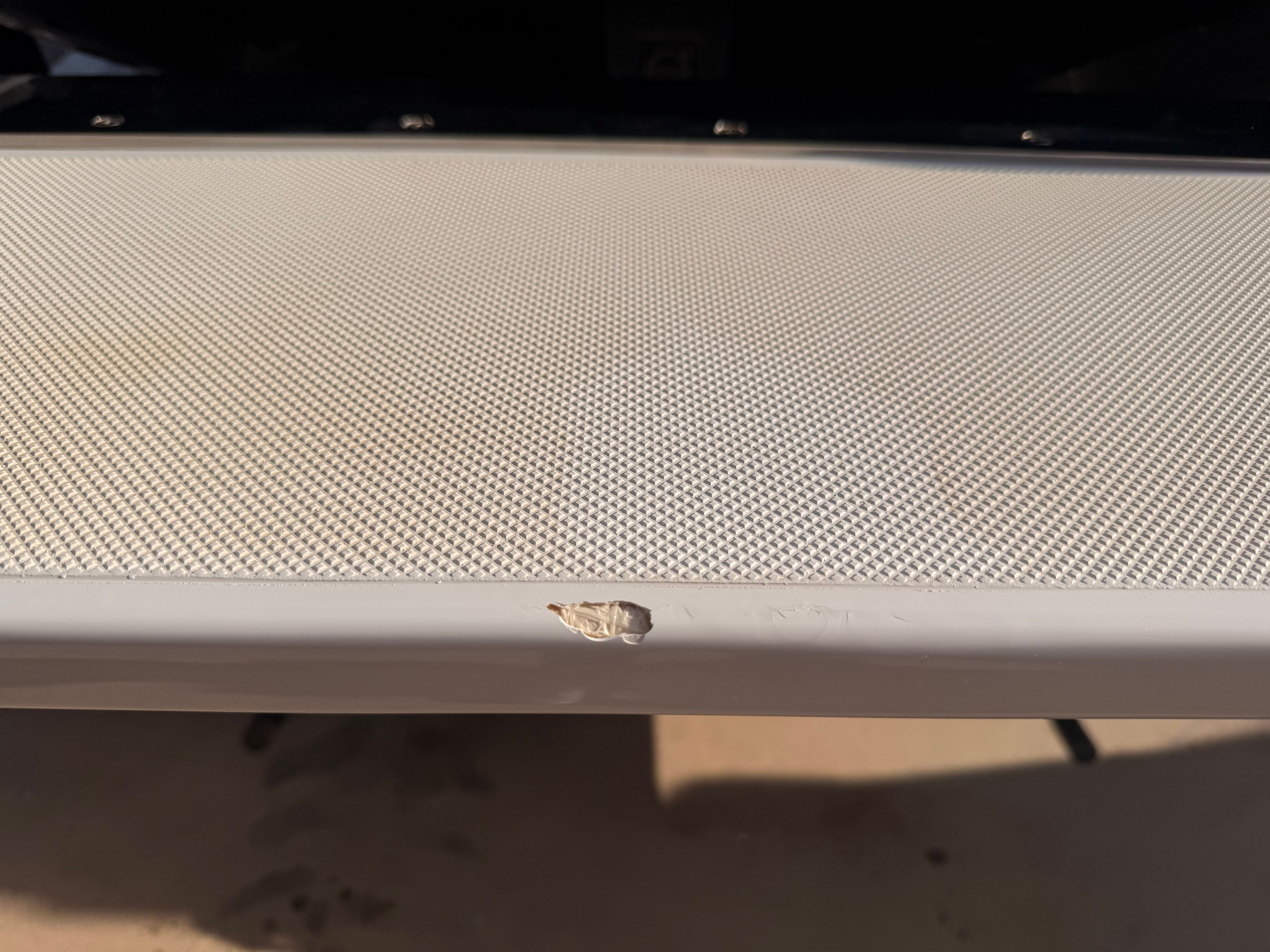Close-up of a boat part with a small chip on the edge.