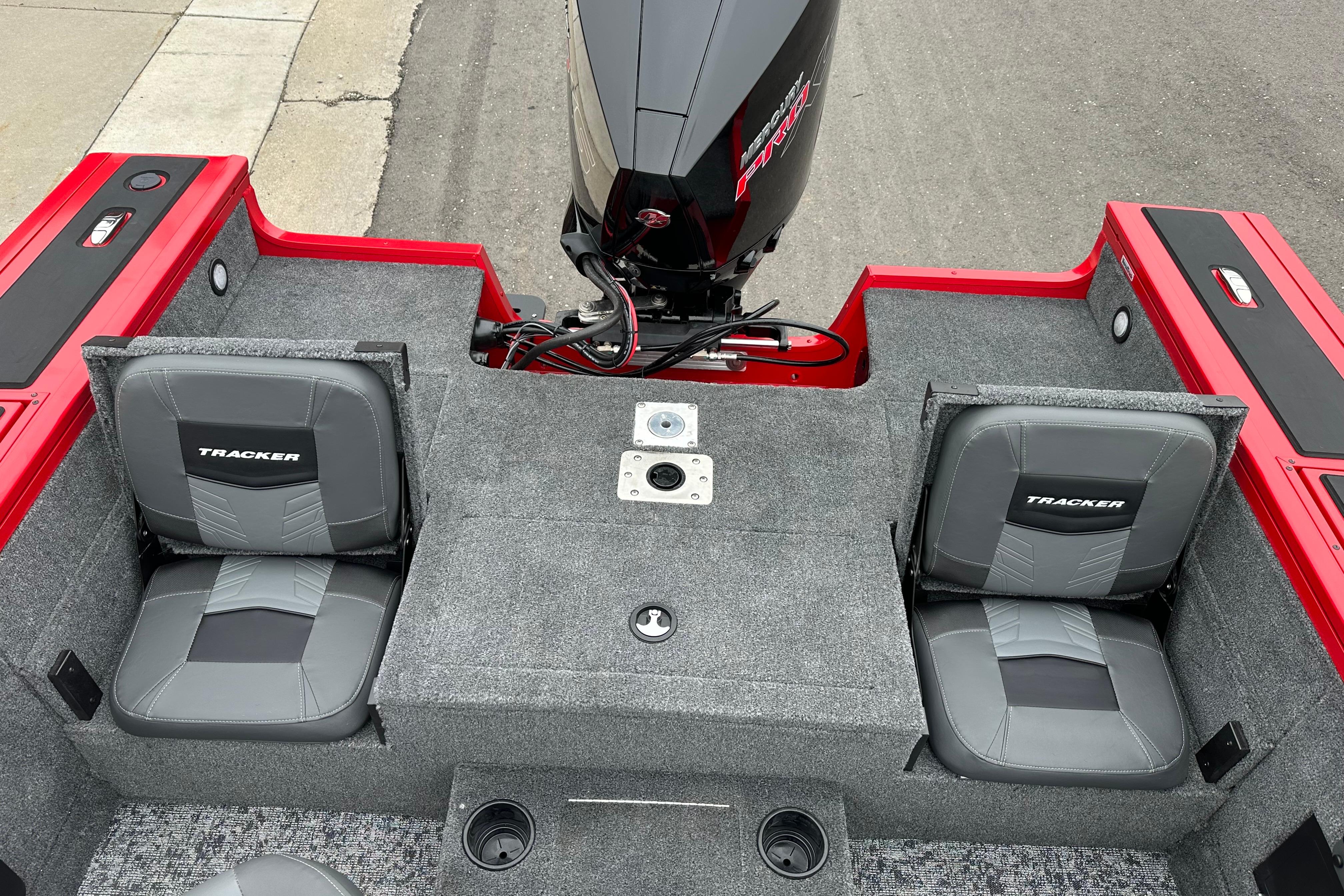 2026 Tracker Targa V-19 Combo boat interior with dual seats and motor, featuring red accents.