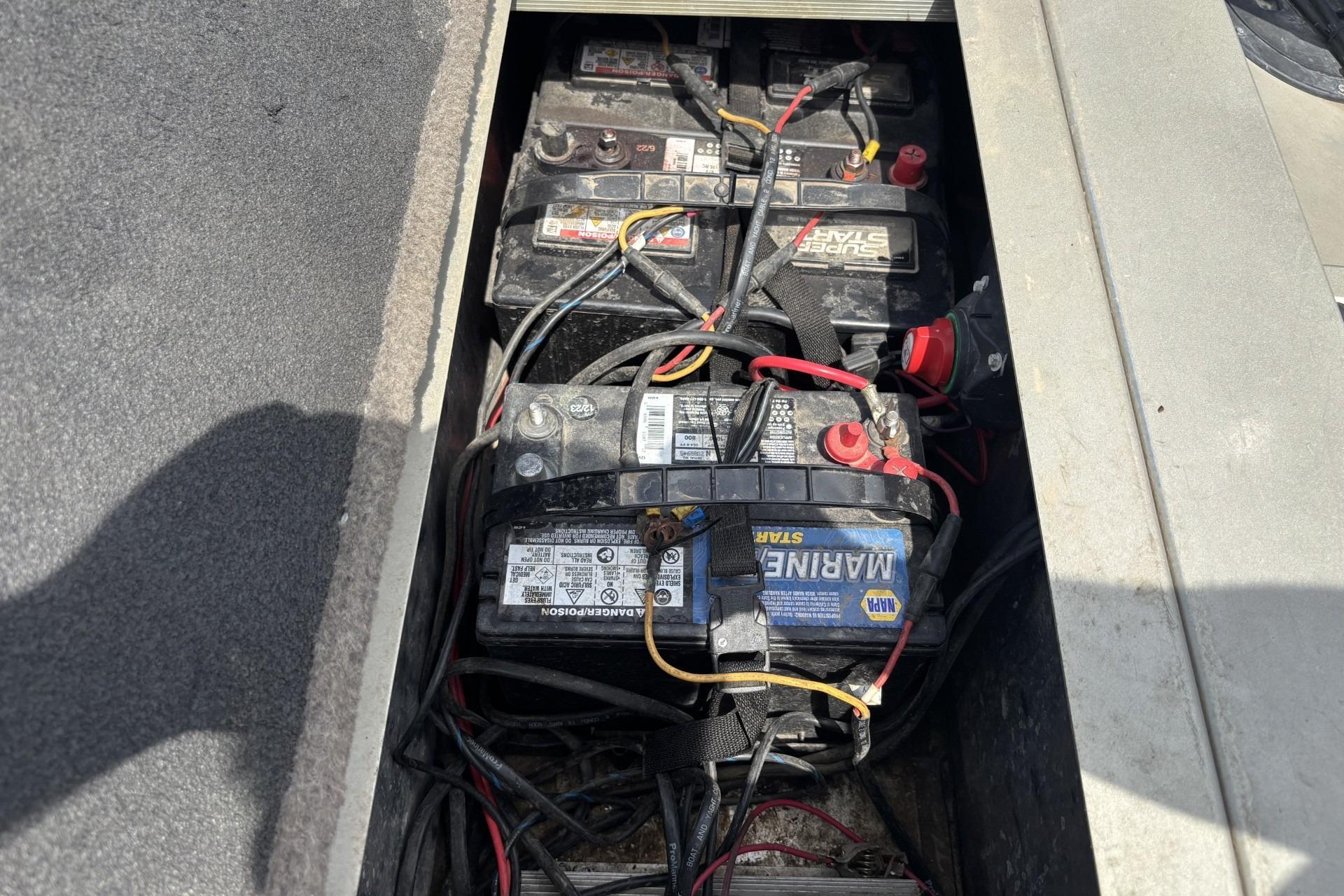 Batteries in a 1999 Tracker Targa 18 boat, showing wiring and connections.