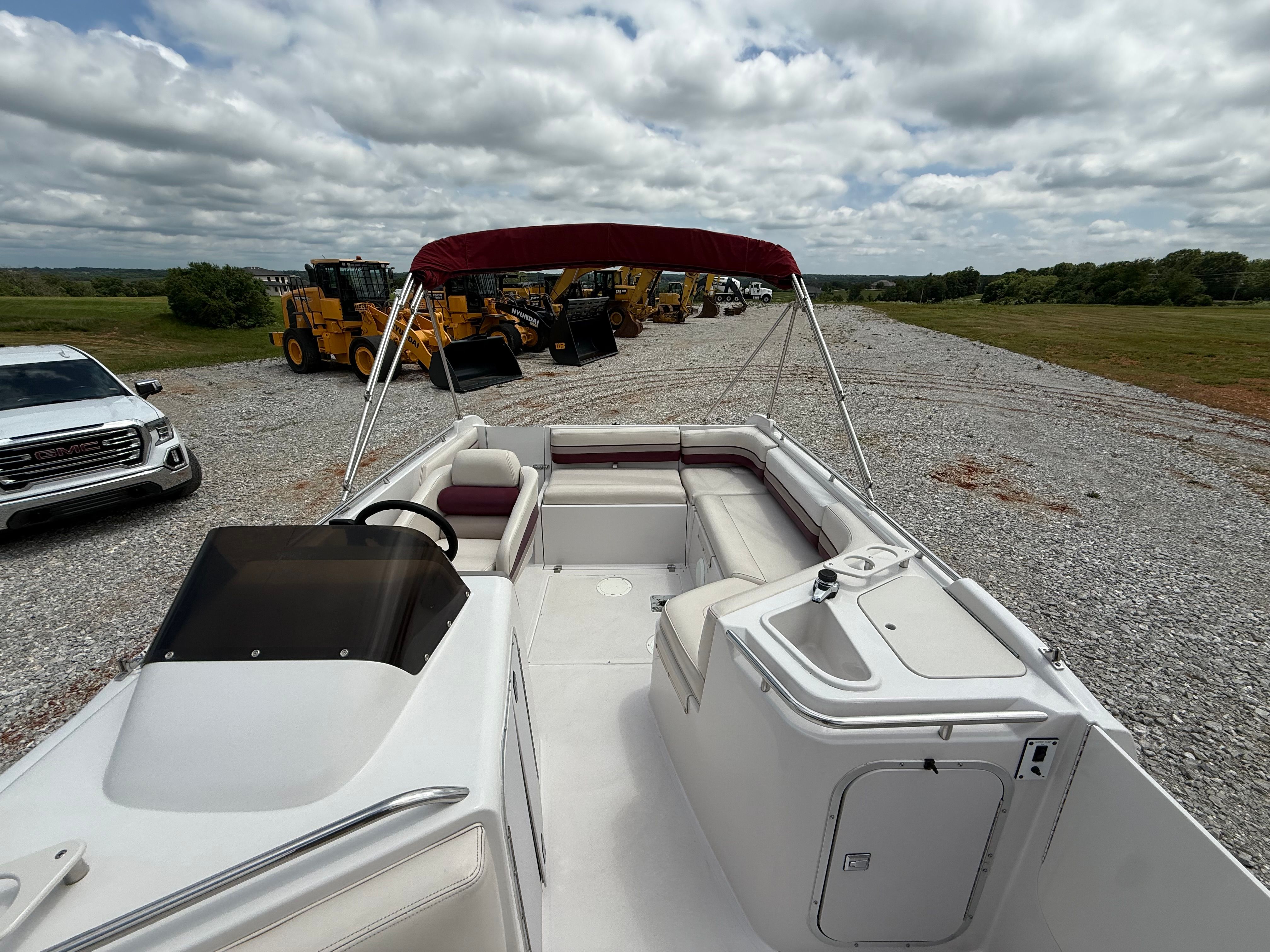 1994 Chaparral Sunesta 220 with open deck and red sunshade.